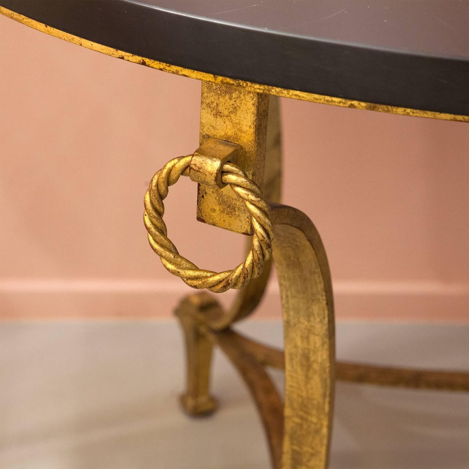 Go glam with this extraordinary specimen of a coffee table. 
Due to the combination of an oval plate crafted from finest slade and the gilded iron base the table serves both as a unique eye-catcher and a classy evergreen.
We are in love with the