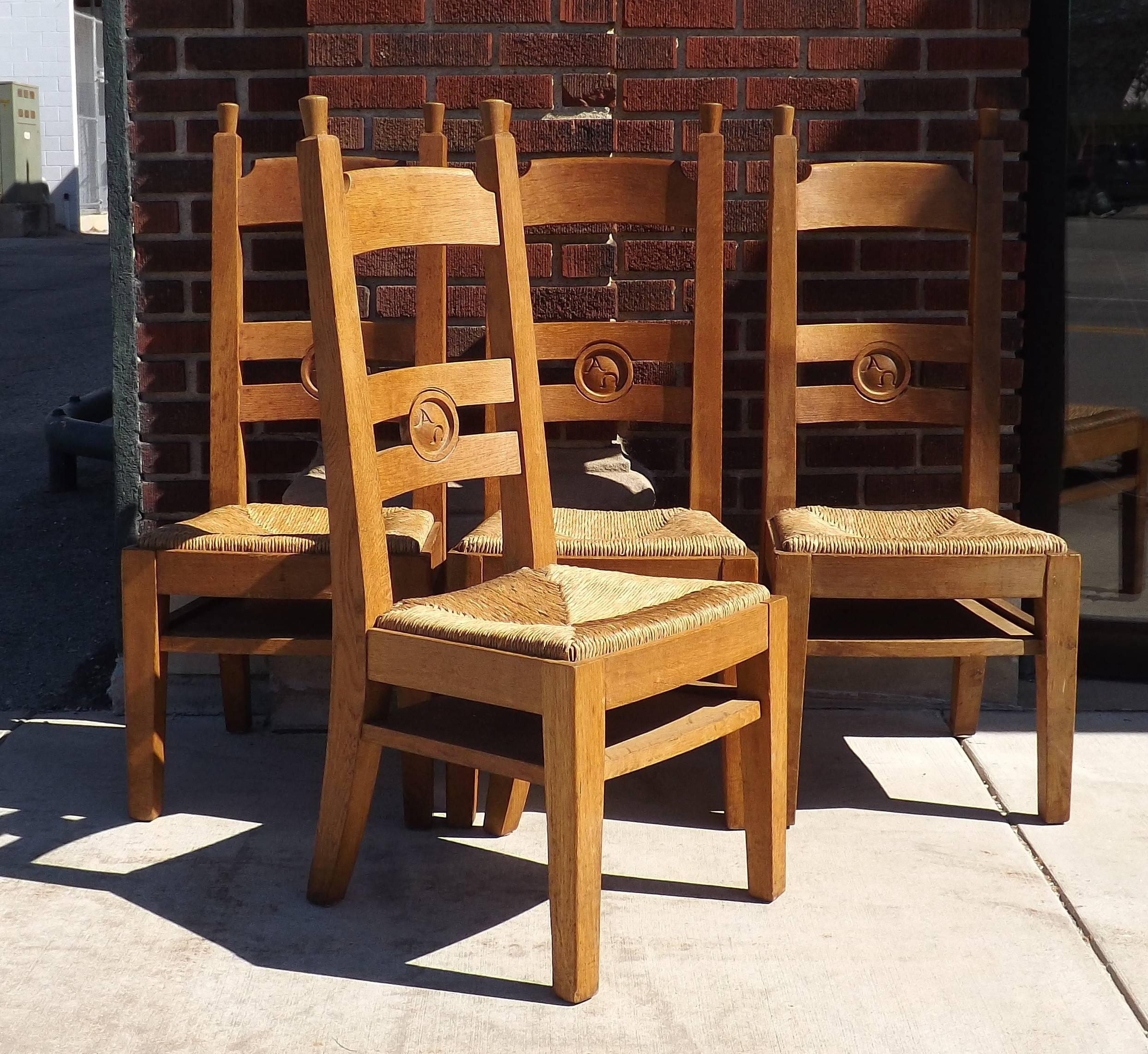 A collection of church chairs from the St. Eusebius church in Arnhem, The Netherlands, 12 in total, carved with 'Alpha Omega' on the backs. Shown in the archival photographs. Priced individually if you might want a set of six or eight chairs. With