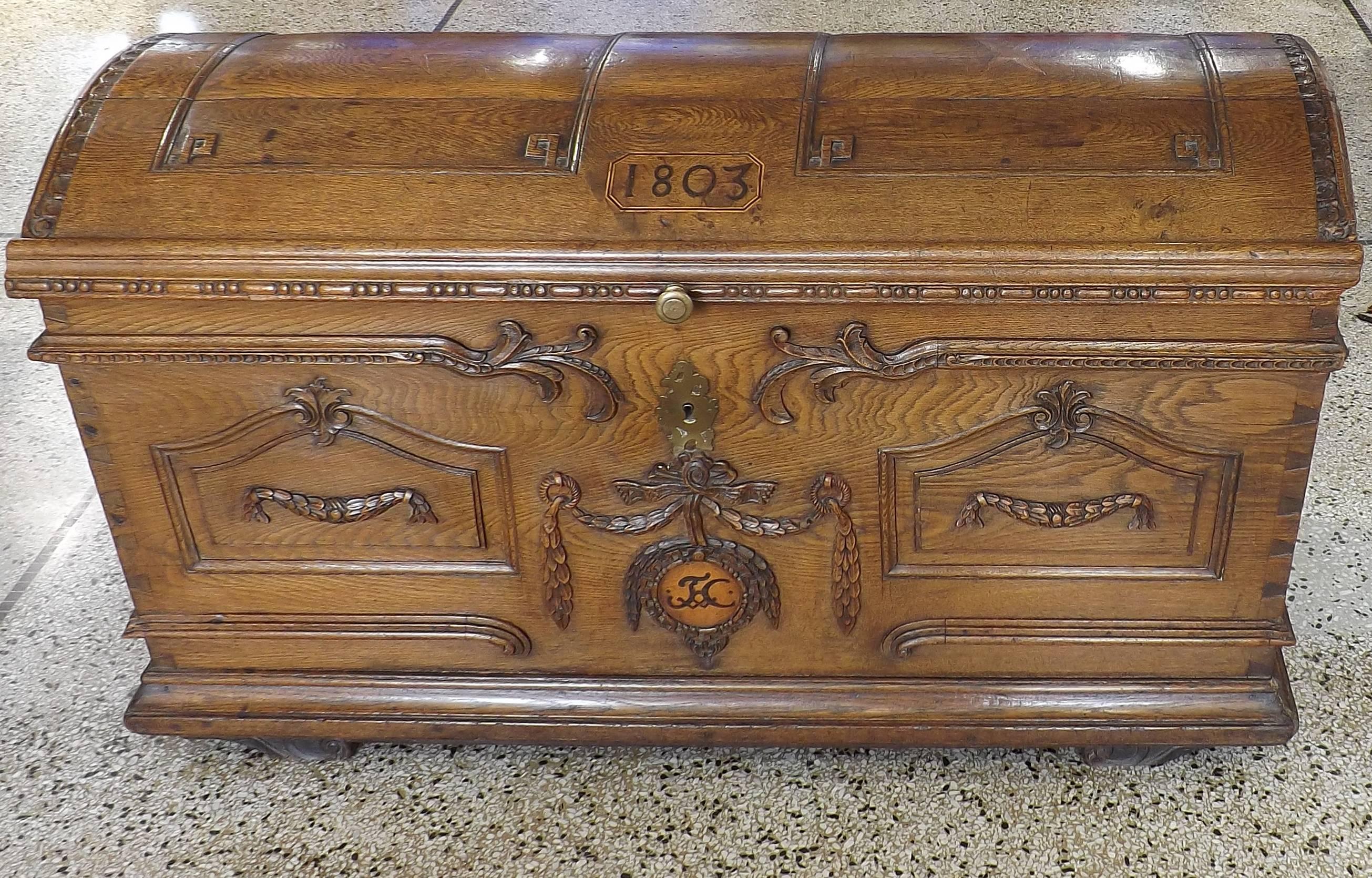 A beautiful Flemish carved oak chest with wrought iron handles, arched lid and inlaid with two six-pointed stars. Dated on lid 1803 and monogrammed with the initials 'F.C'. Key is absent.