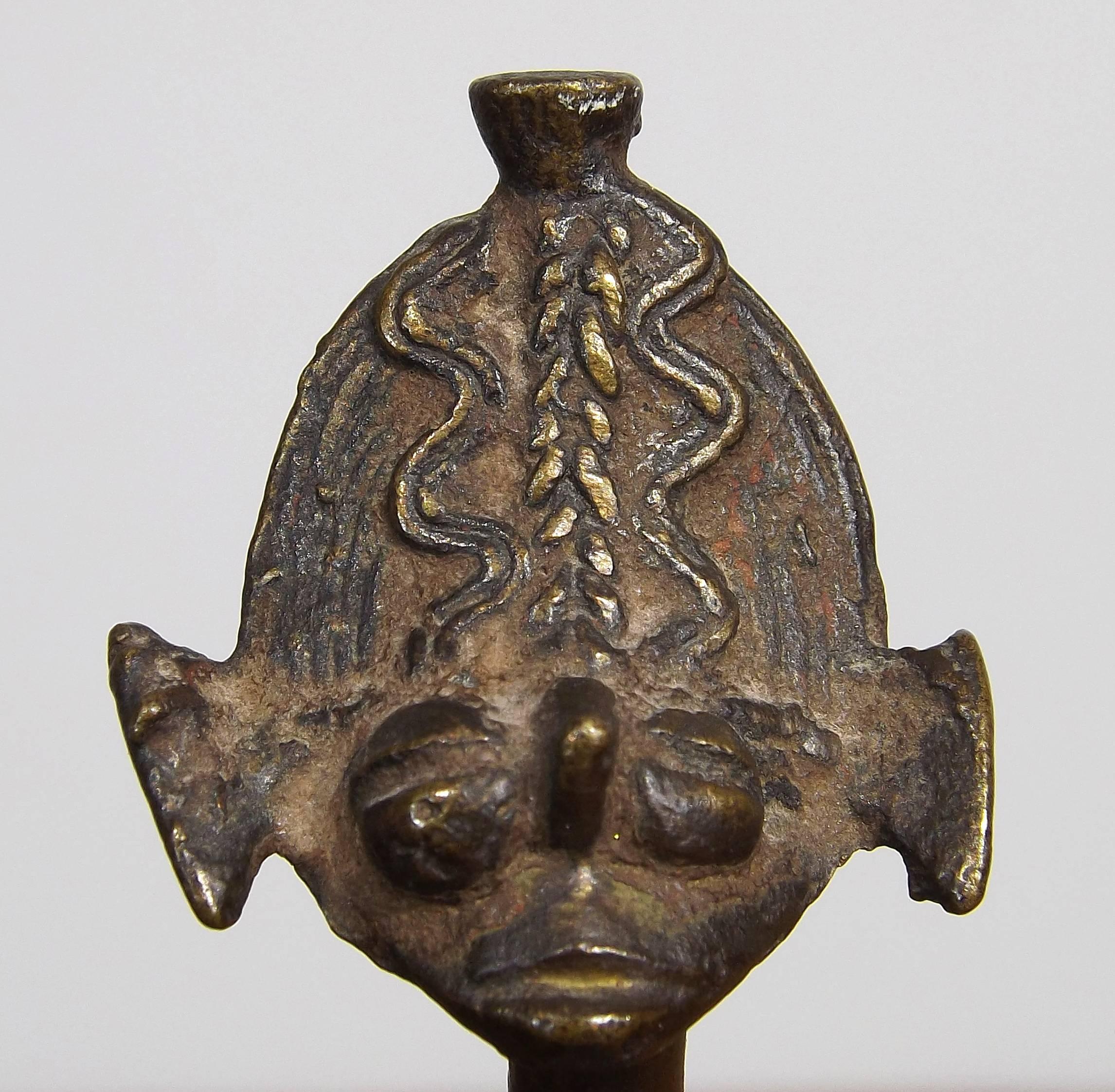 Kulango pendant 'hanyedio' with flattened broad feet beneath a stylized body of convex form. Similar example in Barbier's Art of Cote D'Ivoire, vol 1, 1993, figure 396. It's provenance includes a 1969 bill of sale for the item from Alan Brandt of