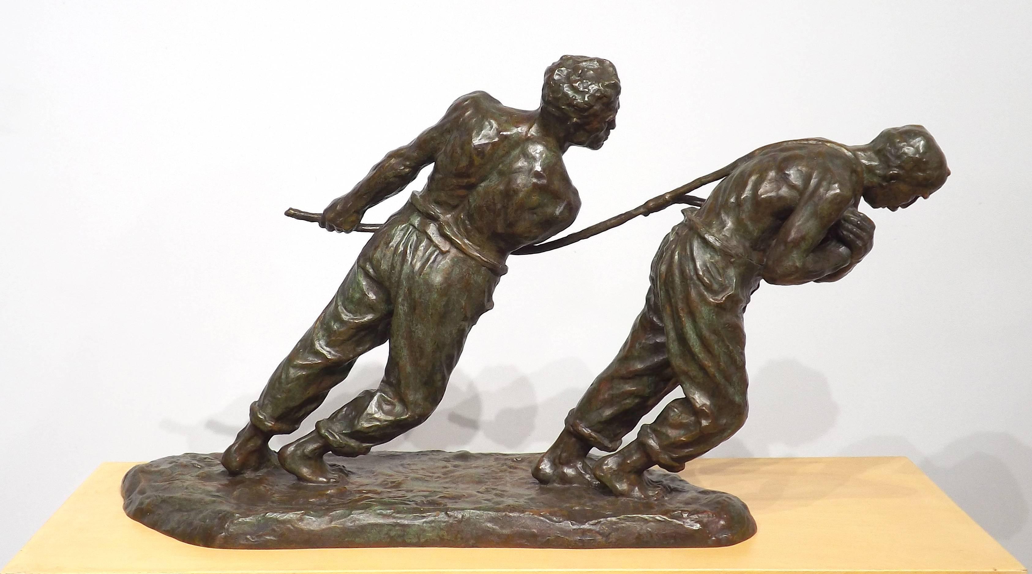 A powerful bronze of two bare-chested men struggling with an unseen weight, bare feet planted in muddy ground and a grim look of determination on their faces. The unseen weight is most likely a loaded river barge.

Born in Belgium,