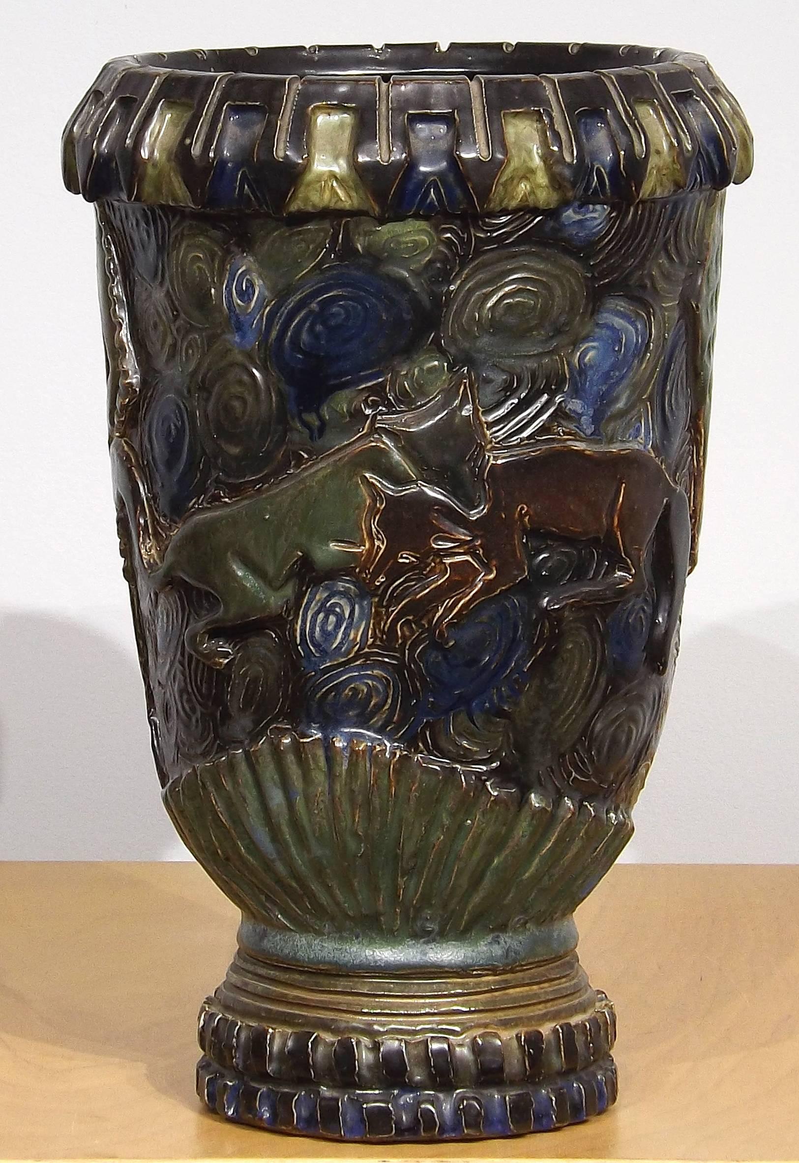 A handsome, almost medieval looking with a modernist feel, decorative vase with two young foxes playing while their mother looks on. Incised 'Guerin Unique' on the bottom. Impressive piece of art pottery.
