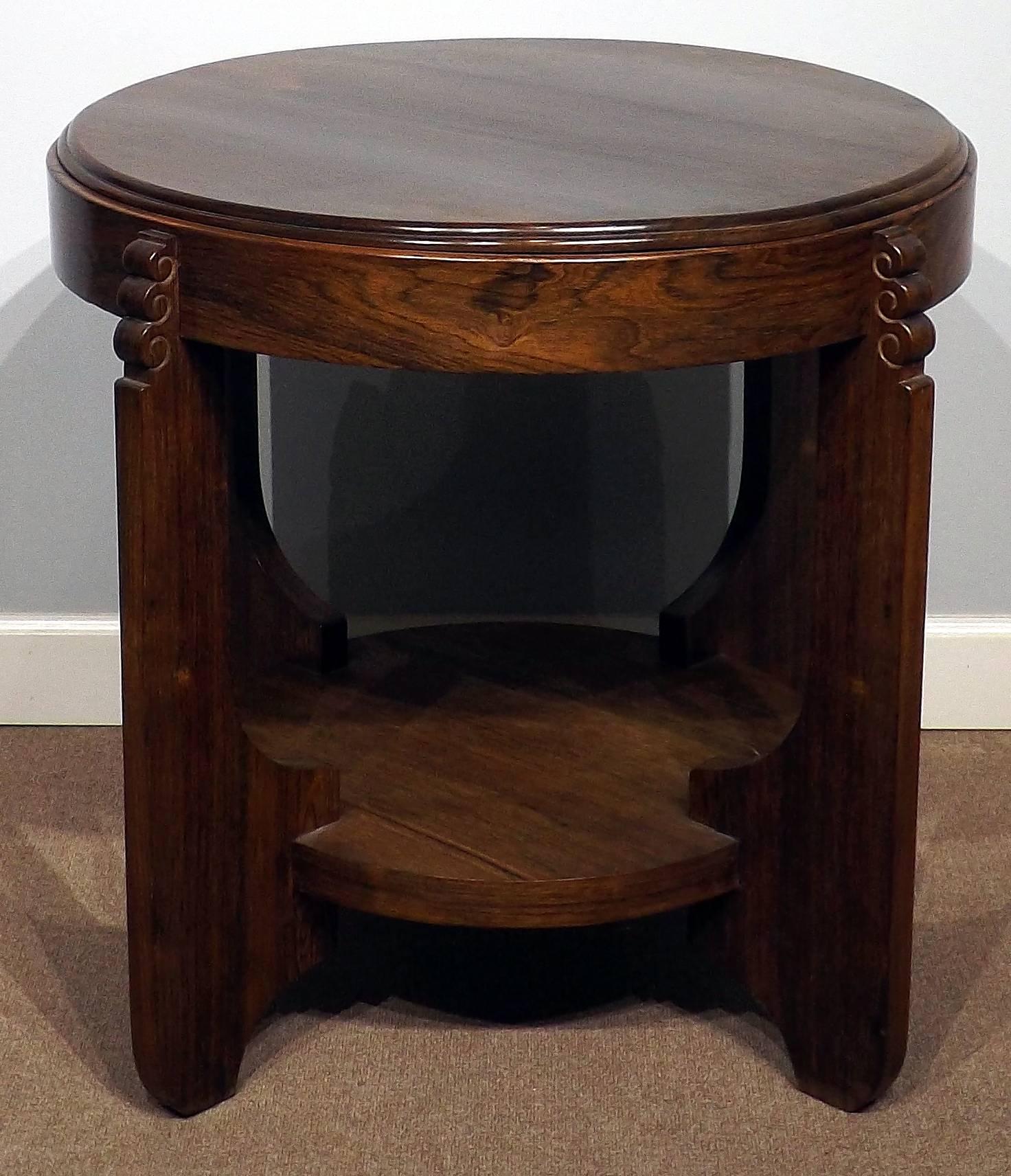 A very nice side table in the style of the Amsterdam Modernism, with a very slight oval design. The table is ornately carved on the legs and has a beautiful finish. It stands 27 1/2 inches tall and the diameter is 30 1/2 inches at it's widest.