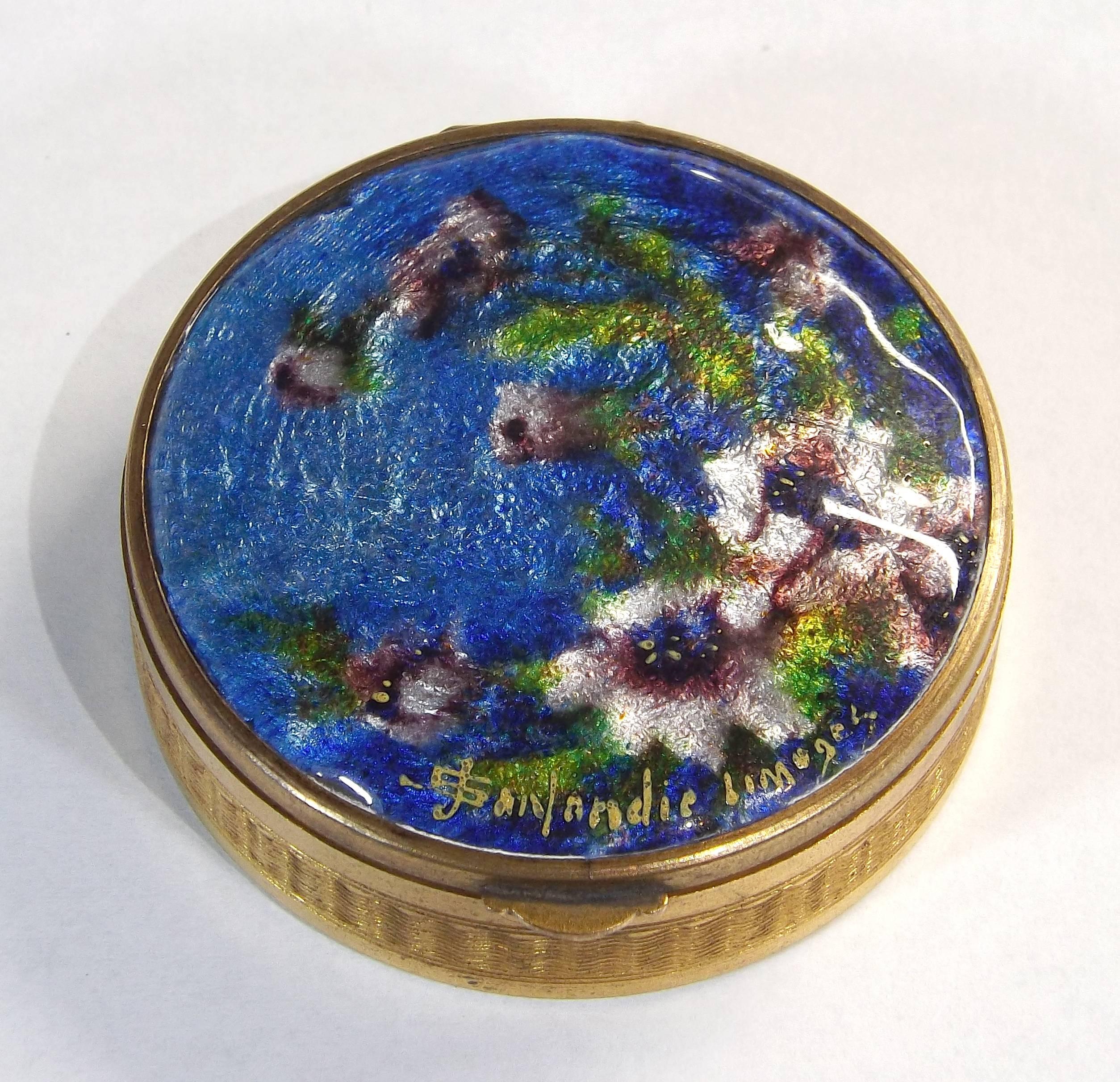 A delicate enameled compact powder box with floral decor by Jules Sarlandie (1874-1936). Of polished brass with a mirror on the inside lid. Excellent condition, measures: 1 3/4 inch diameter.