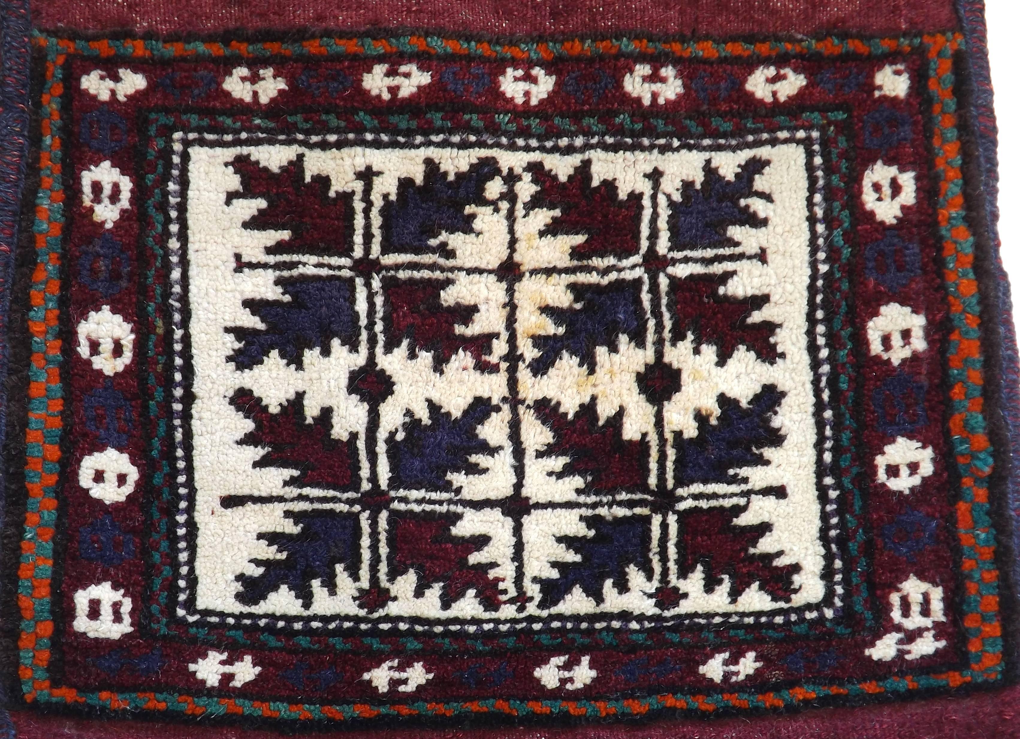 A beautiful handwoven woolen oriental rug bag with twisted tasseled cords. Intricate design on front with bright blues on back. Suitable for use as a rug, as a wall decoration, or even as a pillow.