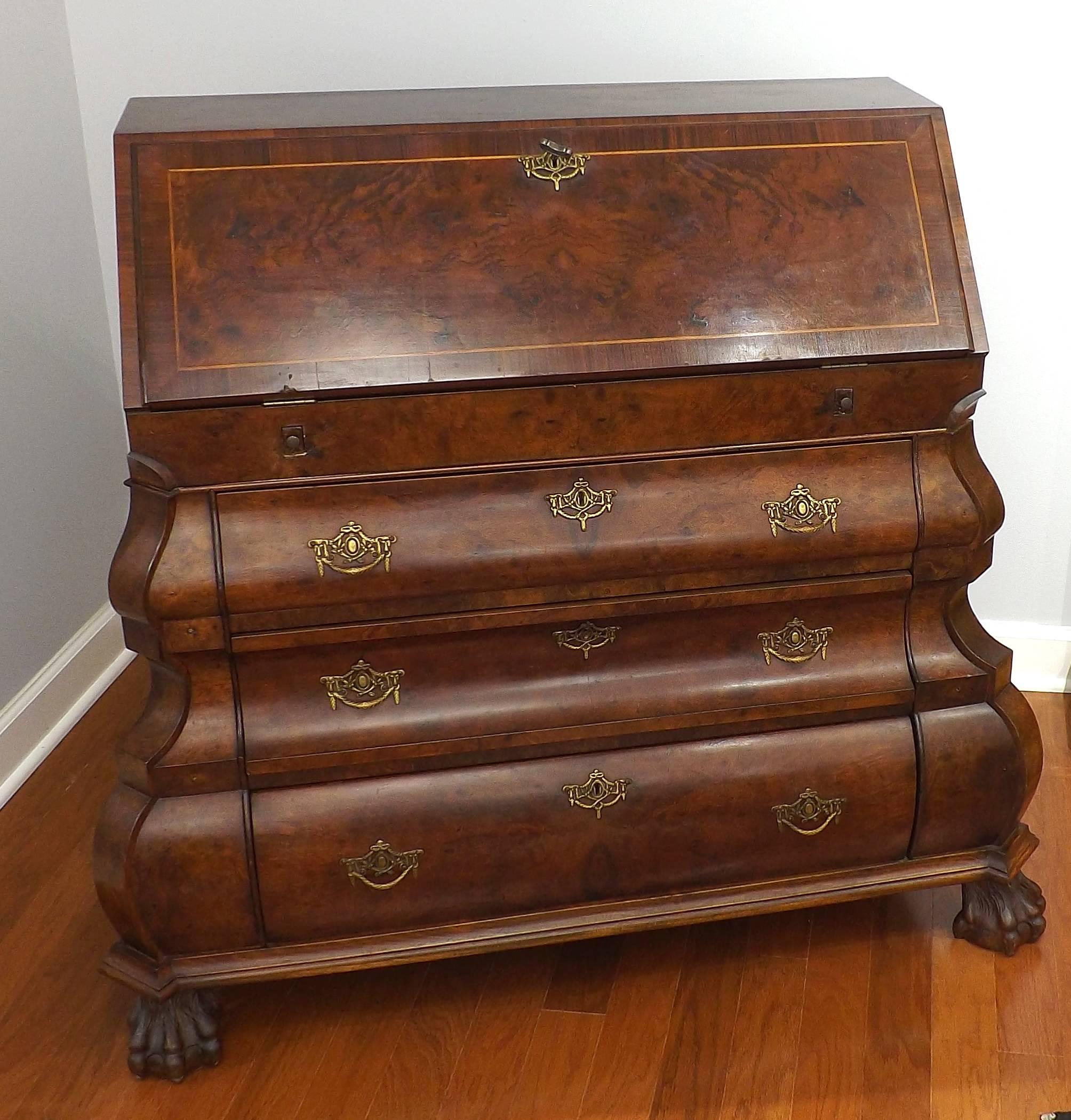 A magnificent Dutch bombe drop front desk with walnut burl and rosewood on claw and ball feet. Beautiful marquetry work and with two 'secret' compartments disguised as books. Two pull-out arms support the fold down writing surface, which can be