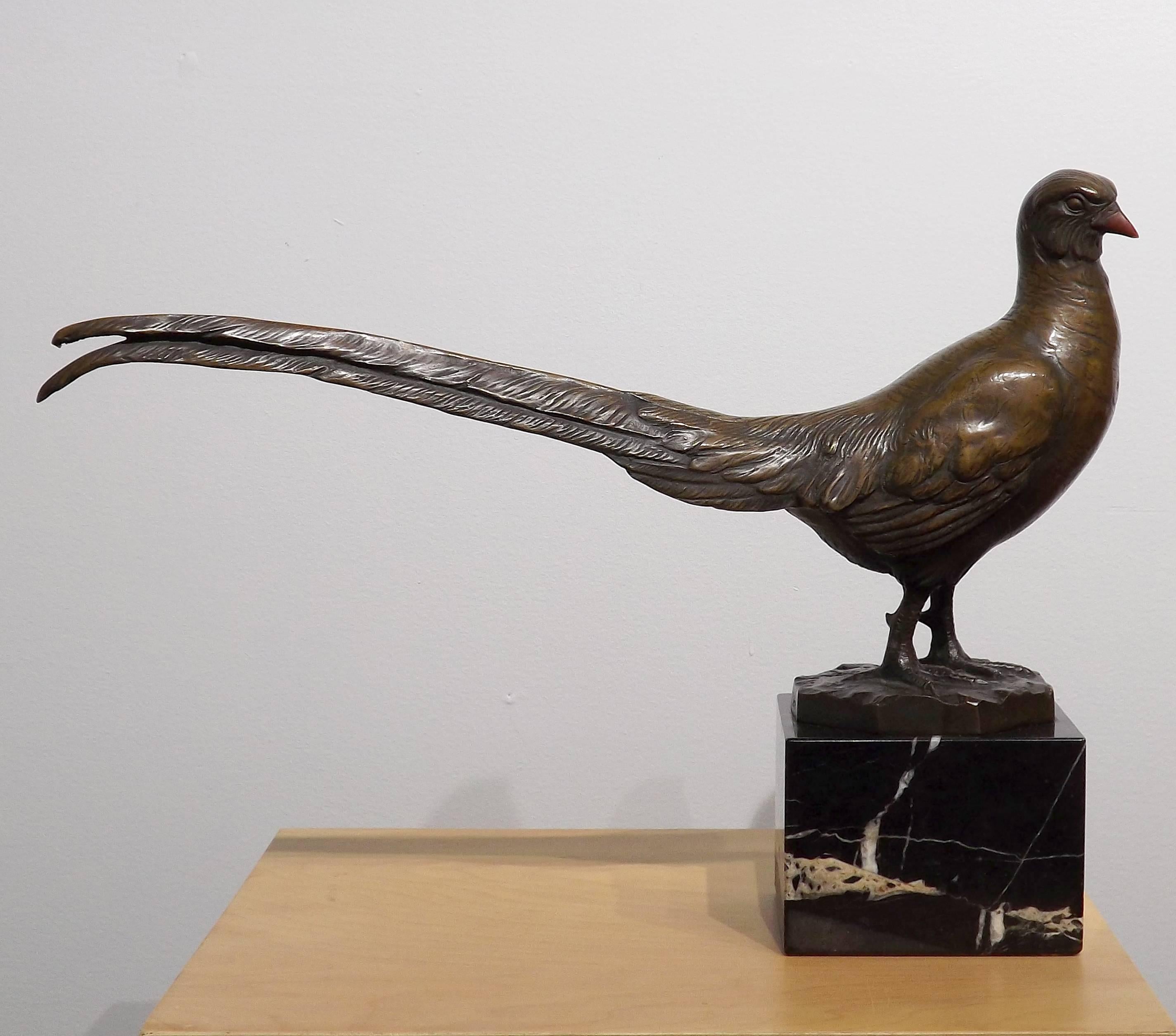 A pheasant poses majestically, it's long tail feathers stretching out behind it in this bronze by Peder Marius Jensen.

Jensen was born in Denmark in 1883, but traveled to Germany for his art education. After a period of study in Dresden, he
