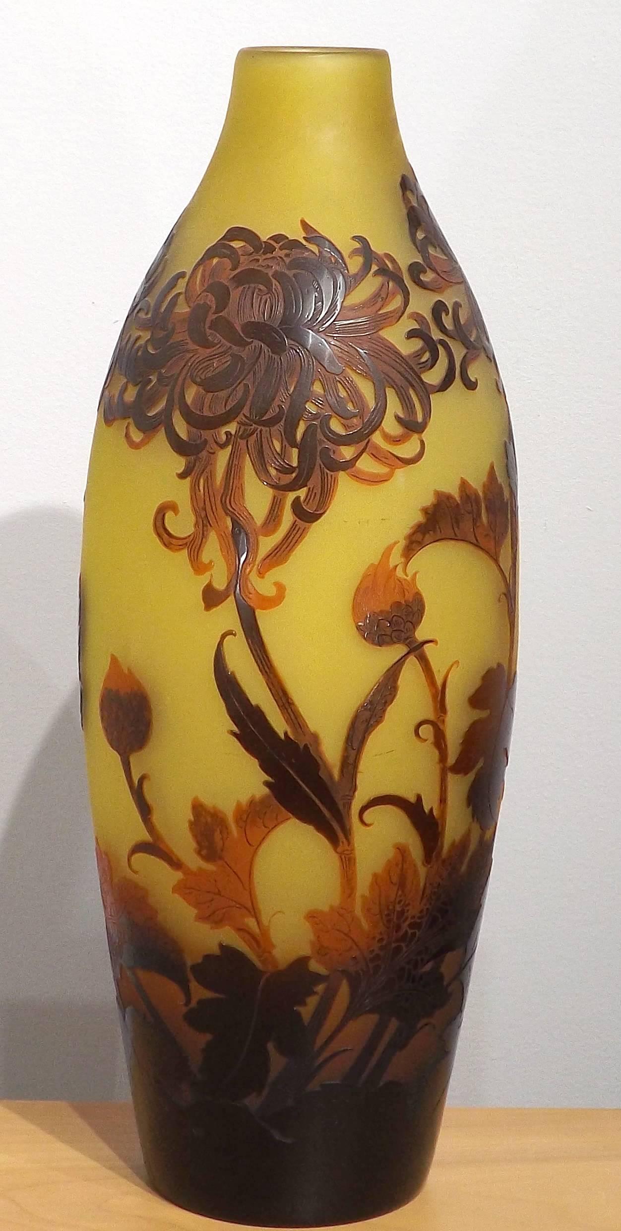 A tall and stunning D'Argental cameo vase decorated with spider mums. Wonderfully graceful leaves arc across the carved surface in amazing detail, the incised surface showcasing the skills of a master glassmaker.

D'Argental was the name given to