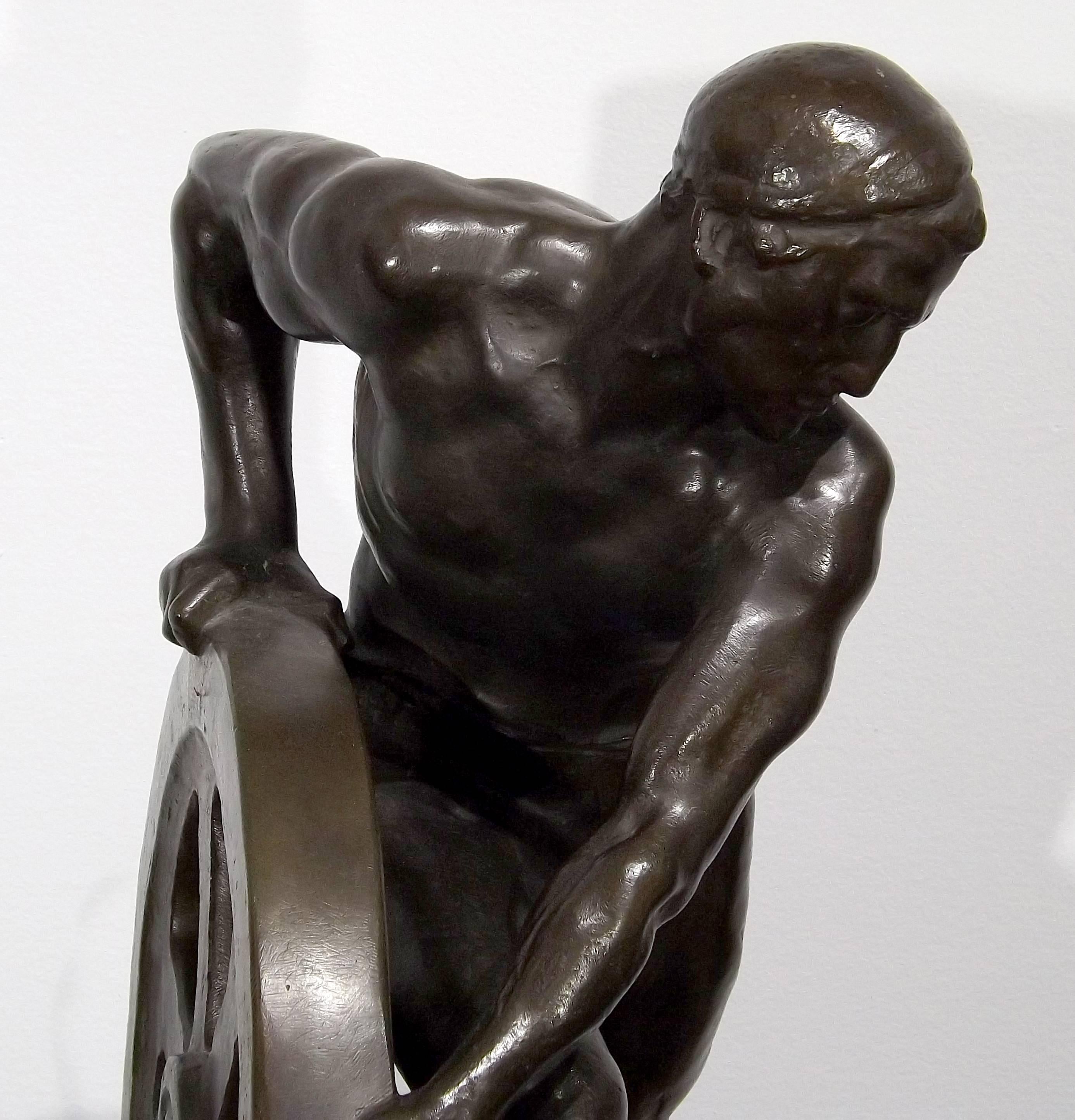 Bronze of a Man Pushing a Wheel by Ernst Seger In Good Condition For Sale In Charlevoix, MI