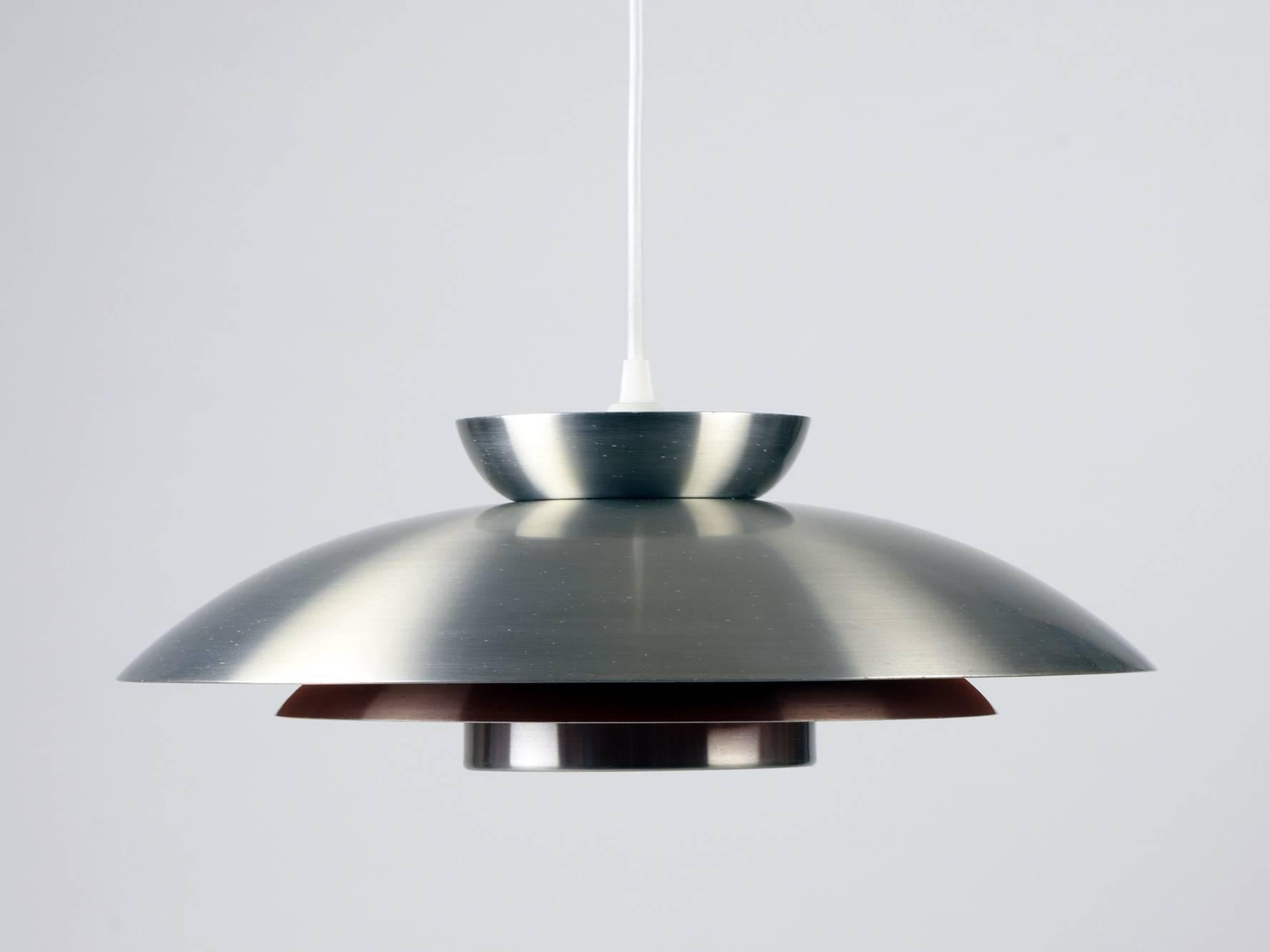 Carl Thore / Sigurd Lindkvist (attributed).
Granhaga (Manufacturer), Sweden.
Ceiling pendant, 1960s.

Brushed metal with orange and white enameled metal inner surfaces.

Attributed to Carl Thore / Sigurd Lindkvist because of the very similar