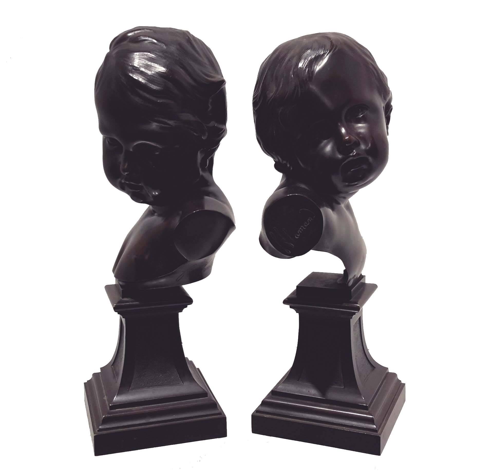 After Francois Duquesnoy (Flemish 1594-1643): A pair of French 19th century bronze busts of young boys, each inscribed 'f. flamand' on bronze pedestal.