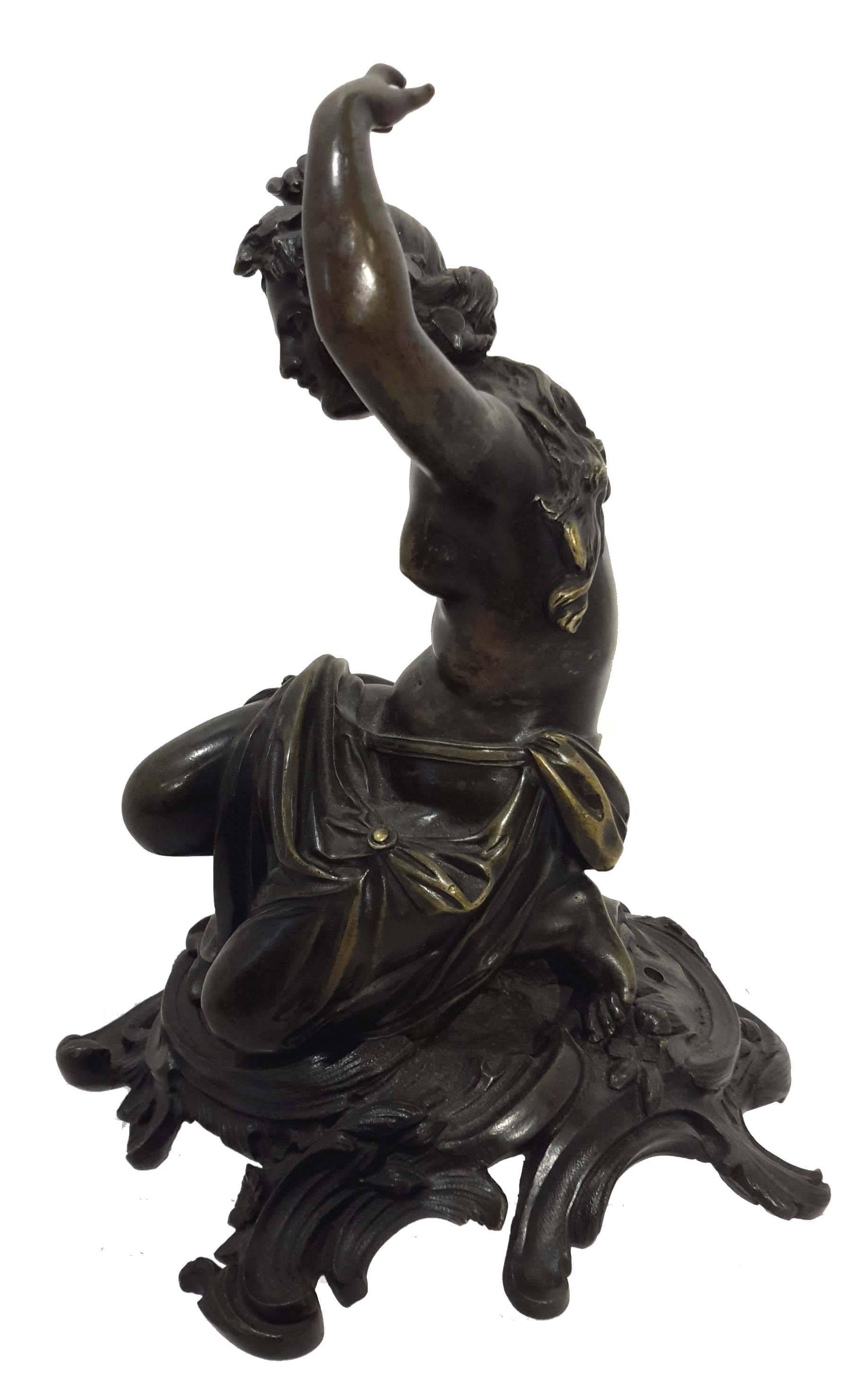 French circa mid-19th century. Beautifully cast bronze of a bacchante sitting and with raised hands dancing. Medium brown patina. on a Rococo style base.