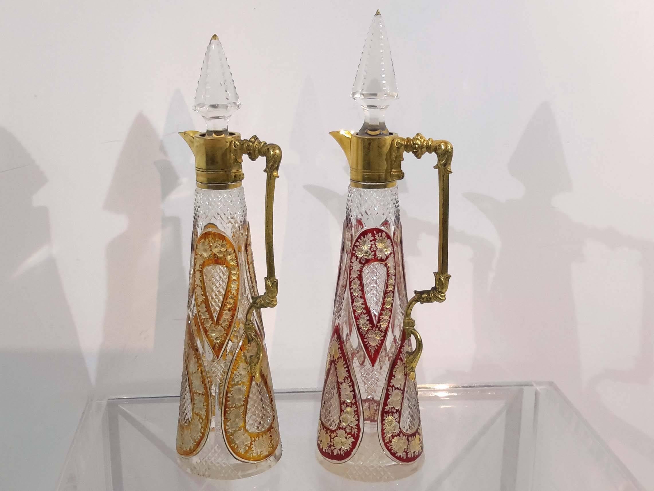 Great quality cut overlay glass with gilt decorations.
Red pitcher is 9 1/4 inches high, wide 2 1/4 inches
Yellow pitcher is 9 inches high, wide 2 1/4 inches.