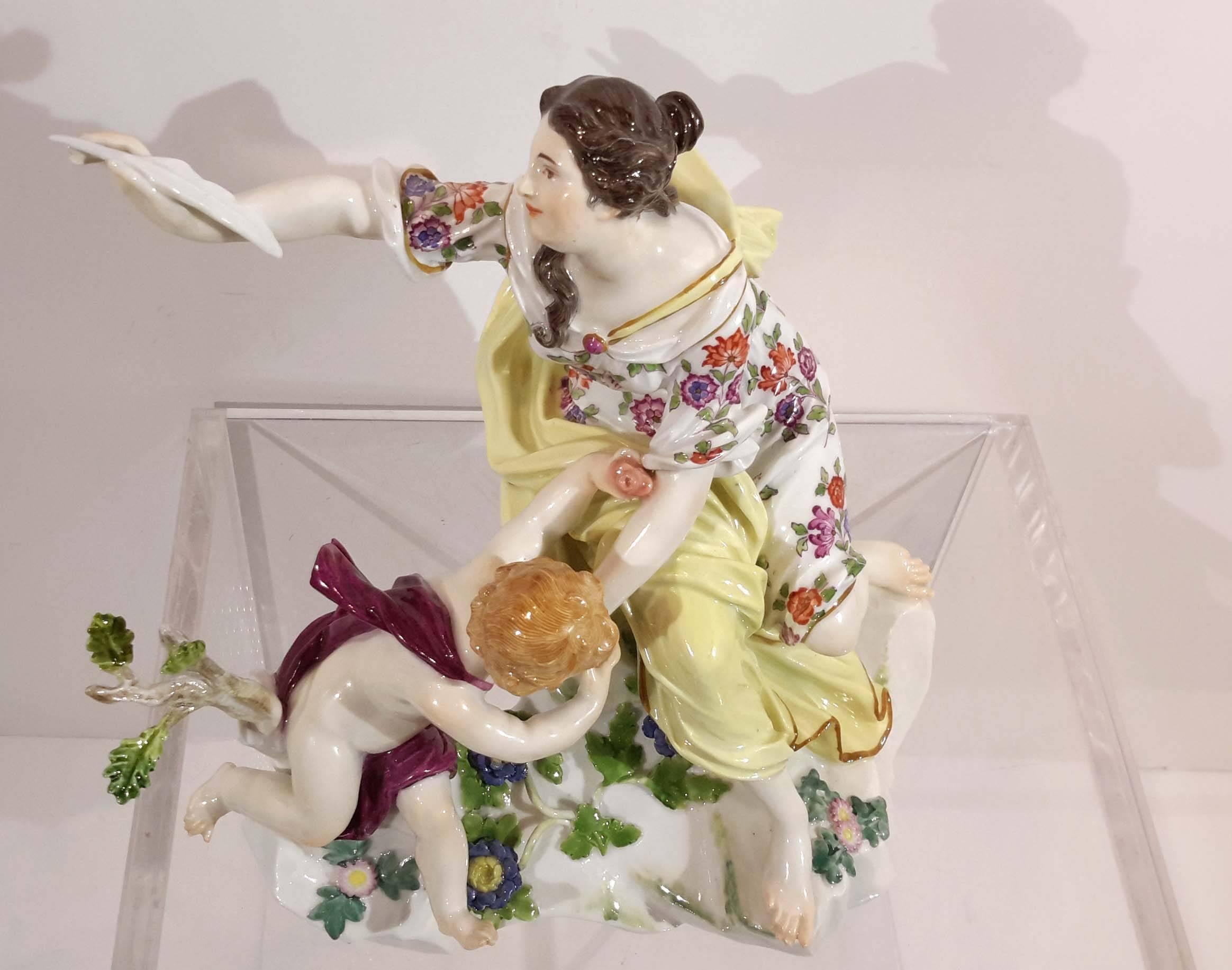 First quality Meissen. Underglazed blue crossed swords mark,
depicting an allegorical scene with a maiden holding a pen and a cherub kissing her left hand.