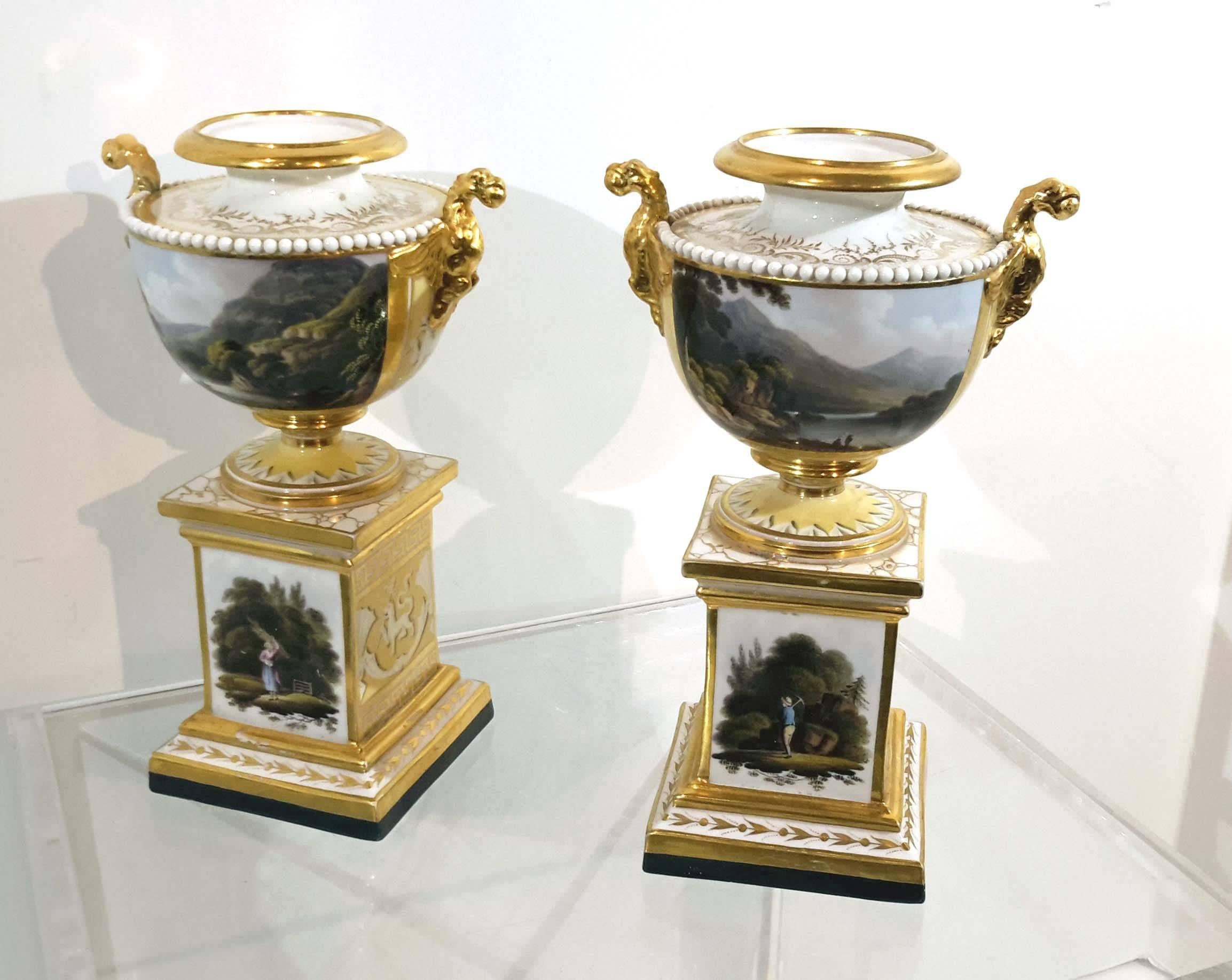 Great hand-painted decorations depicting views of lake Killarney, and another Irish landmark marked in bottom.
These pair of urns possibly had lids at one time.
There are restoration to handles and some minor surface scratch to the base.