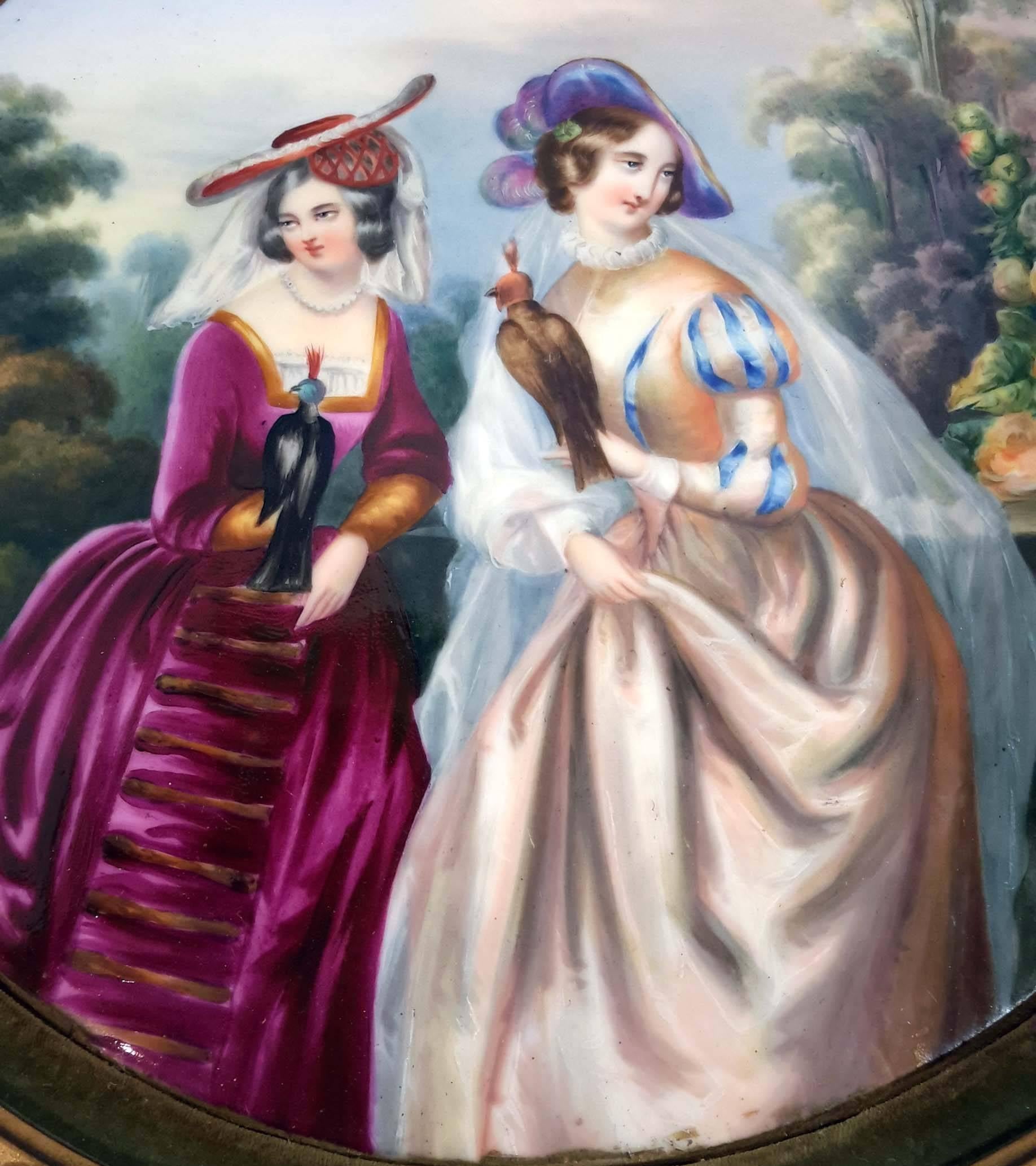 Continental round hand-painted porcelain plaque in gilt frame. Great details, depicting two lady falconers.