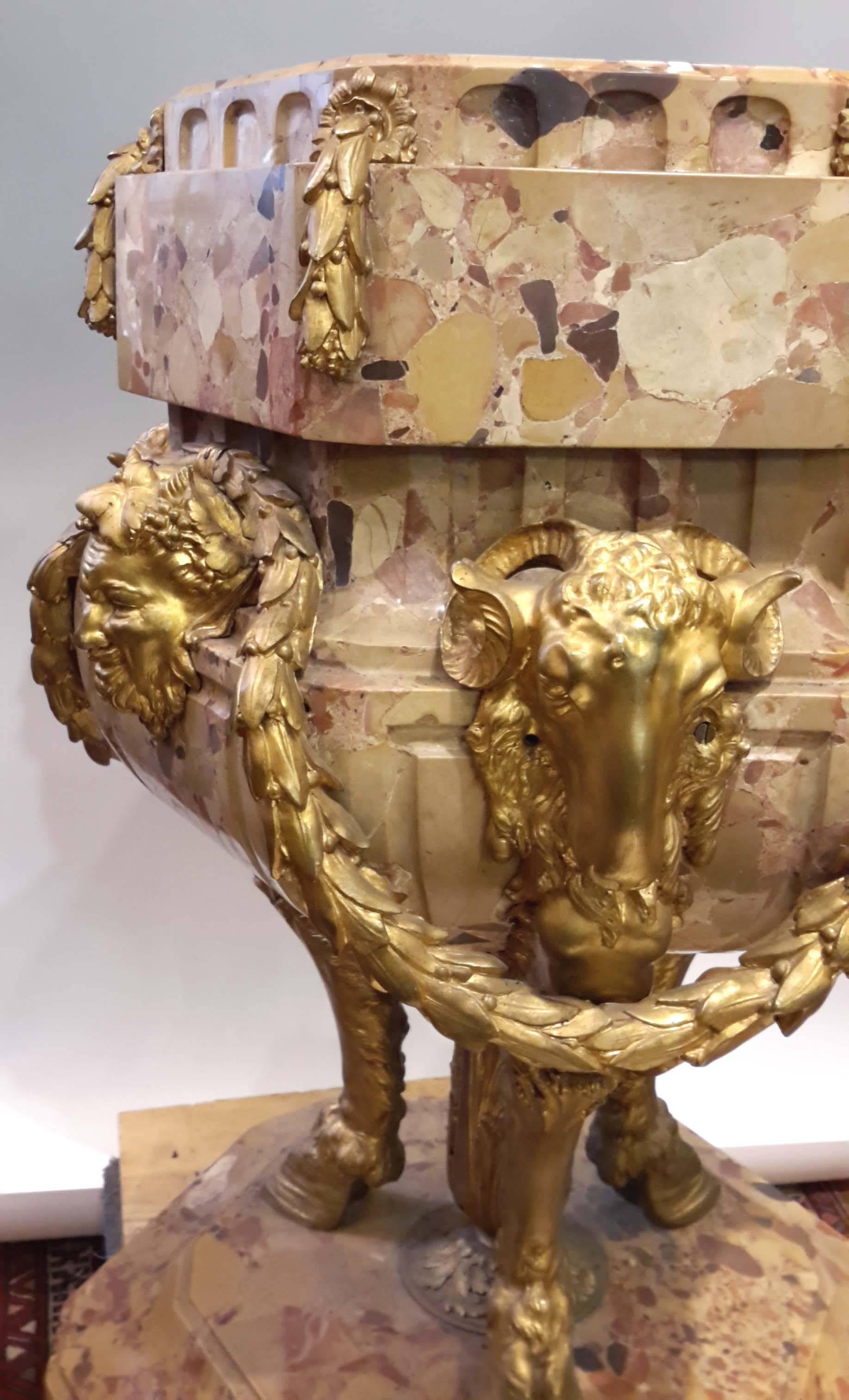 French, circa 1890. Great quality gilt bronze and marble Jardinière, planter.
Solid Breche D'Alep Marble with heavy cast and gilded bronze mounts of garlands, rams heads and masks of Bacchus.