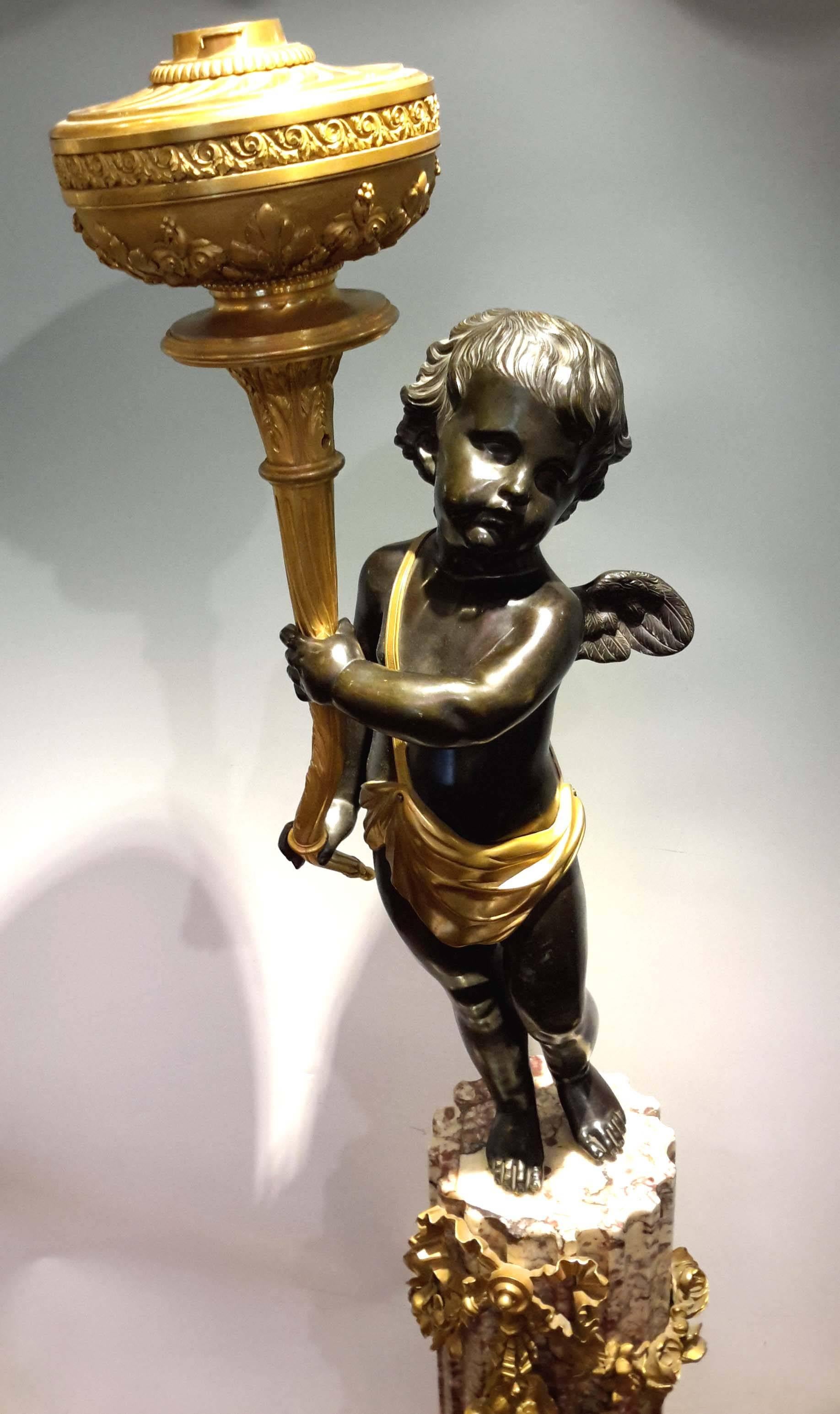 Signed: H. Vian Paris. Gilt and patinated bronze cherub mounted on a marble pedestal with gilt bronze mounts. Originally an oil lamp. Later electrified

 Overall 72