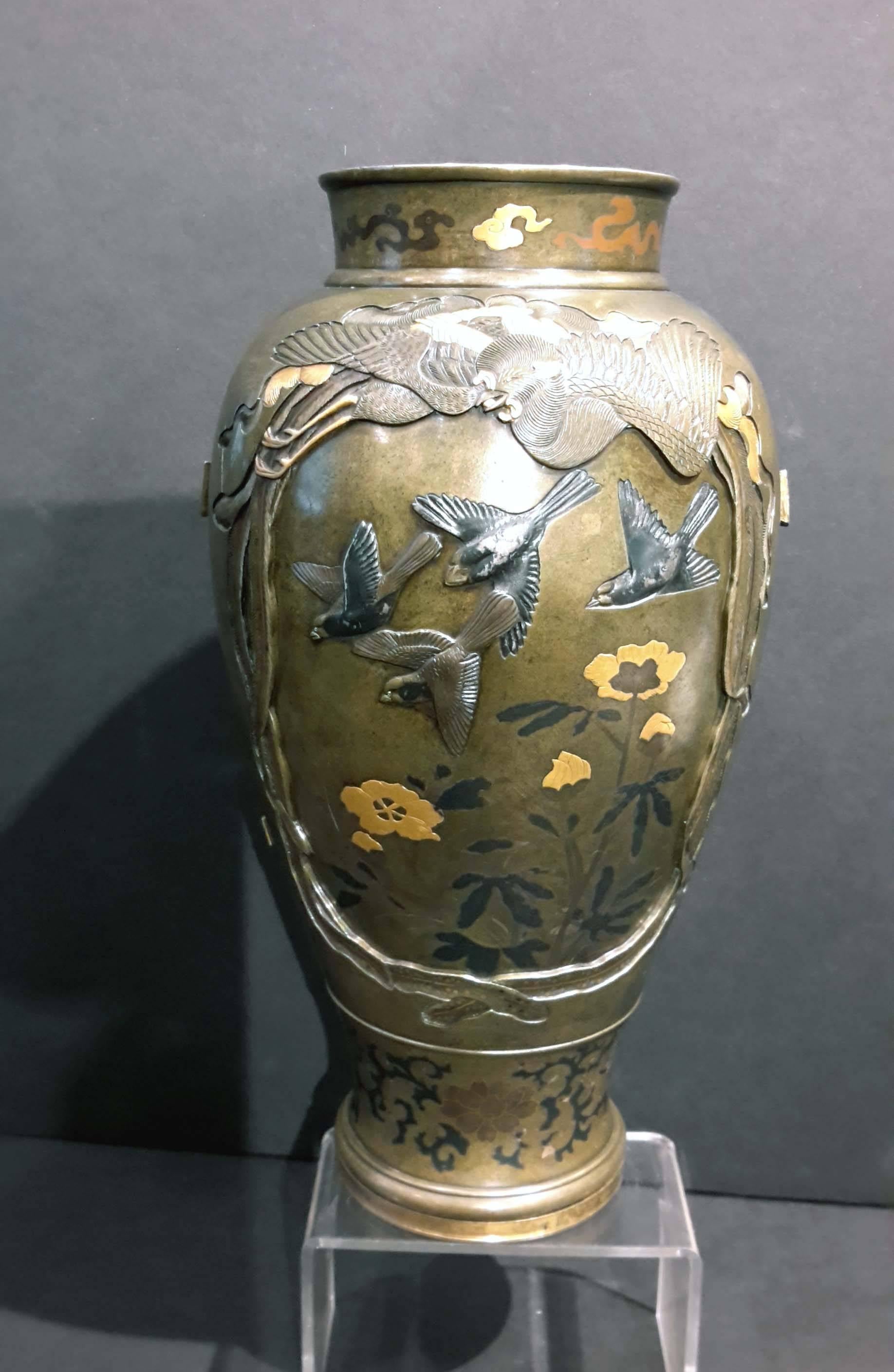 Great quality bronze vase inlaid with gold and silver. Depicting a falcon on one side and birds flying on the other, surrounded by a phoenix on each side.
Meiji period, late 19th century.
 