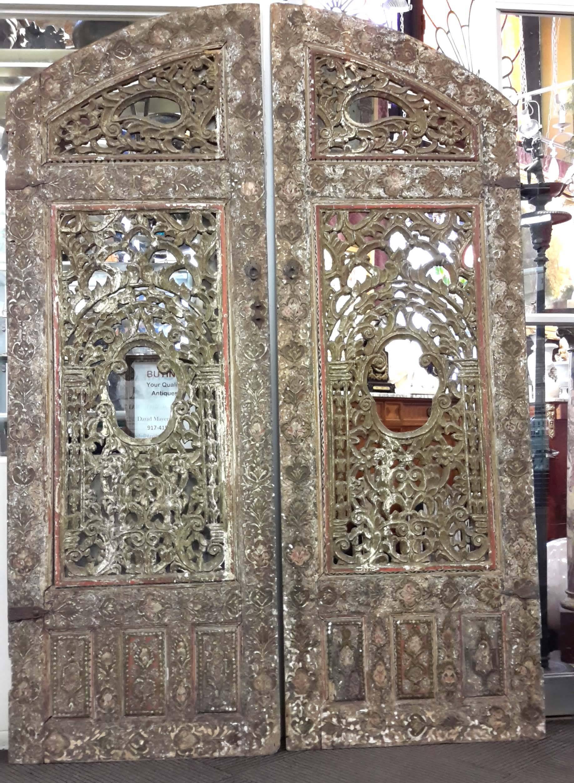 Beautifully carved and poly-chromed. These are altar doors from an Ottoman mosque.
Height is approximately 80 inches.
Each door is approximately 27 inches wide
Depth approximately 2 inches.