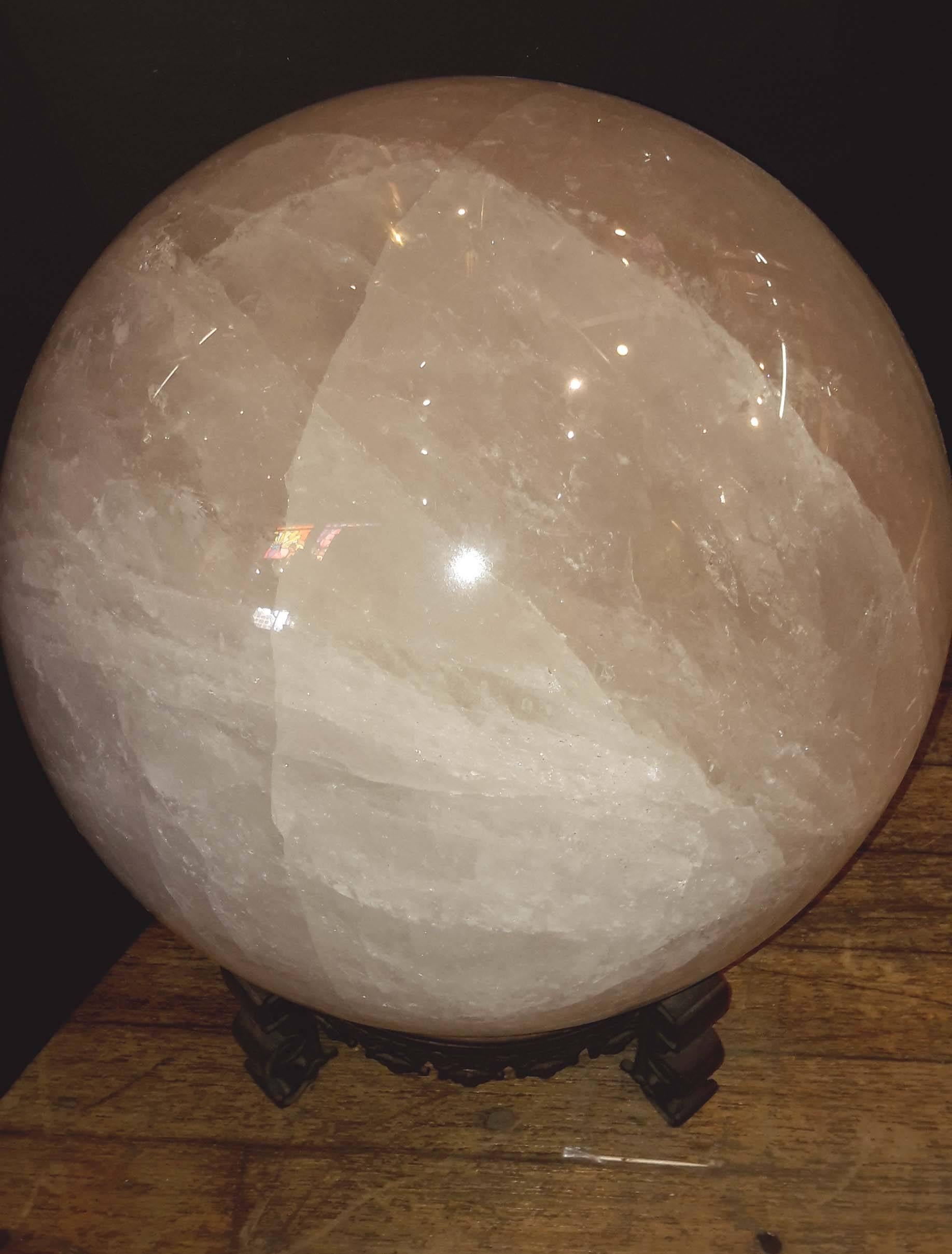 17 inches high on base, 13 inches diameter.
A beautiful specimen of natural quartz crystal with many great inclusions.
On a patinated Bronze chinoiserie French stand.
This sphere weighs over 100 LBS.