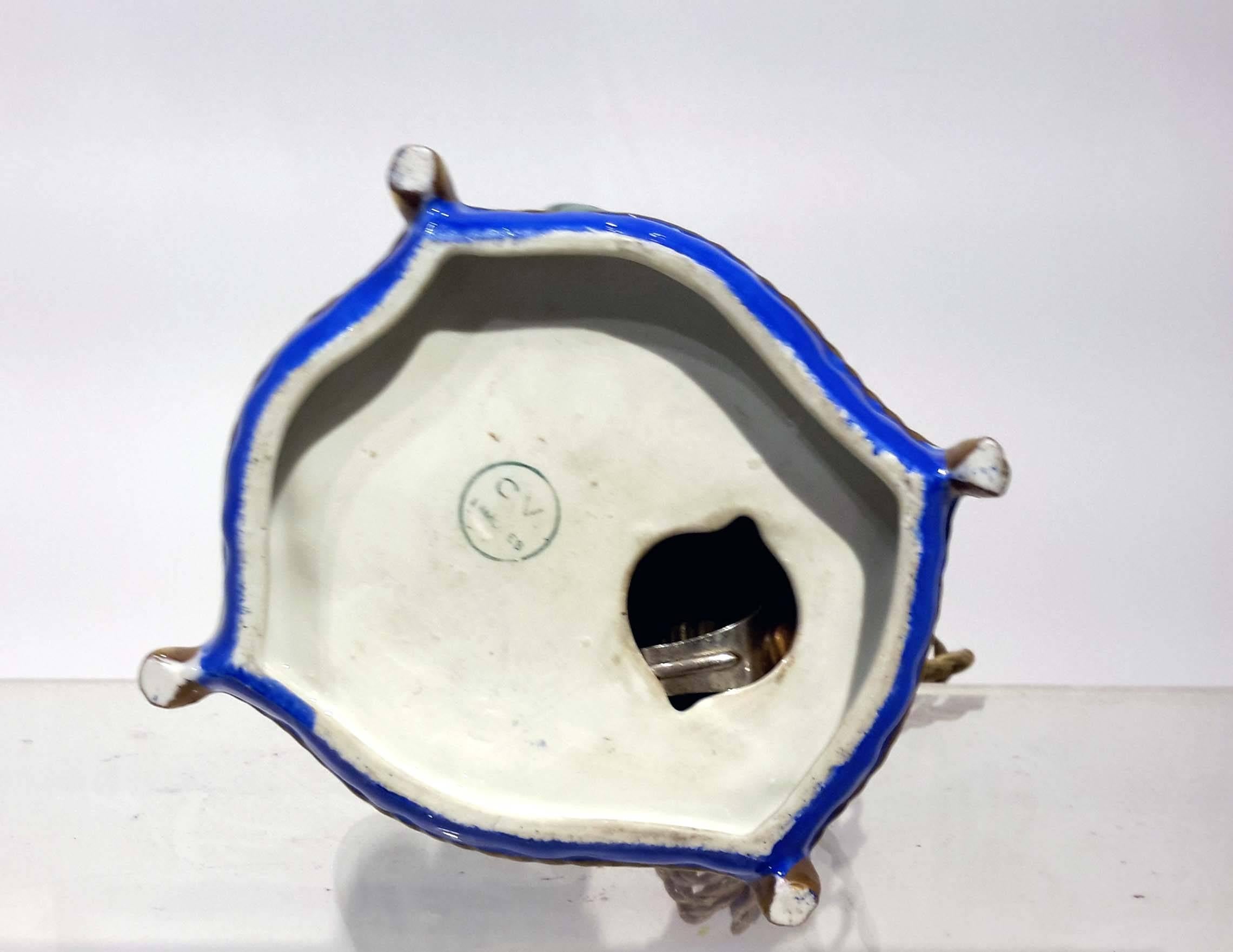 Early 20th century Limoges porcelain perfume lamp, electrified, depicting an oriental figure brewing a potion.
 