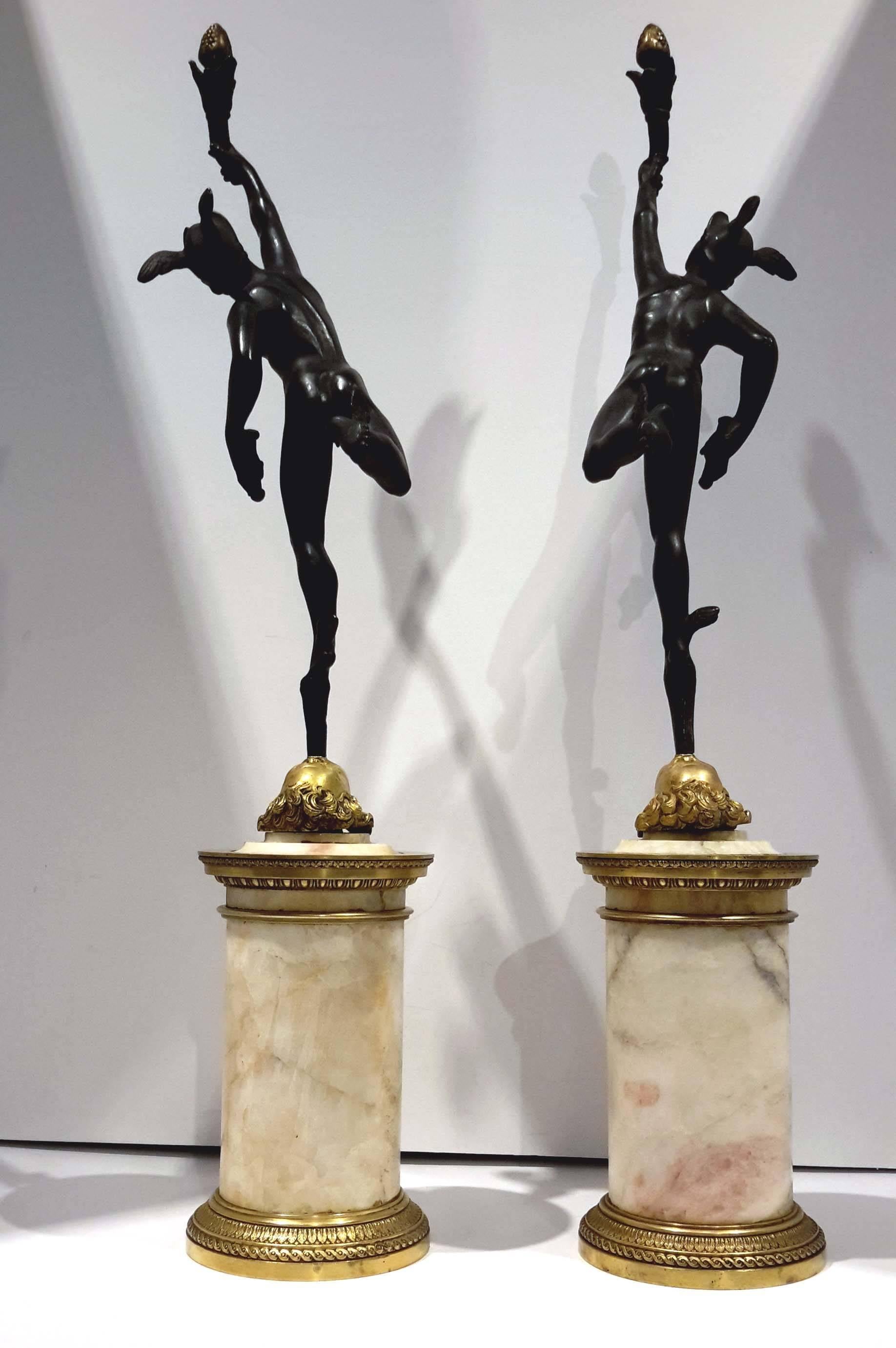 The Marble bases are ormolu mounted in Empire style.
The Bronze figures after Giambologna are patinated and have great details.
The tops are finials but also have candleholders is gilt bronze.
 