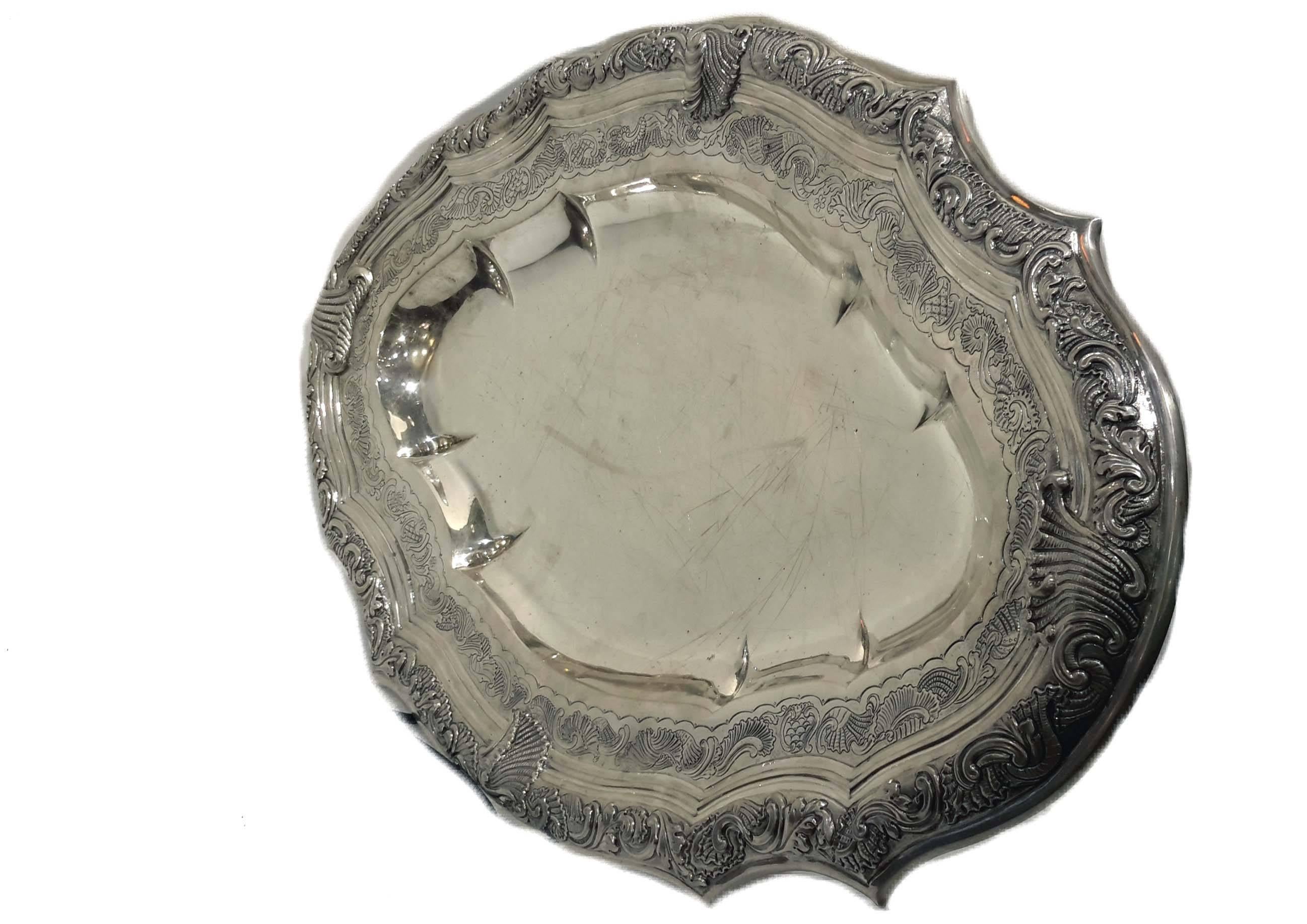 Possibly Peruvian. All hand-hammered and hand chased, circa late 18th or early 19th century.
There are only some letters and numbers engraved in the back. This platter weighs about 55 troy ounces.