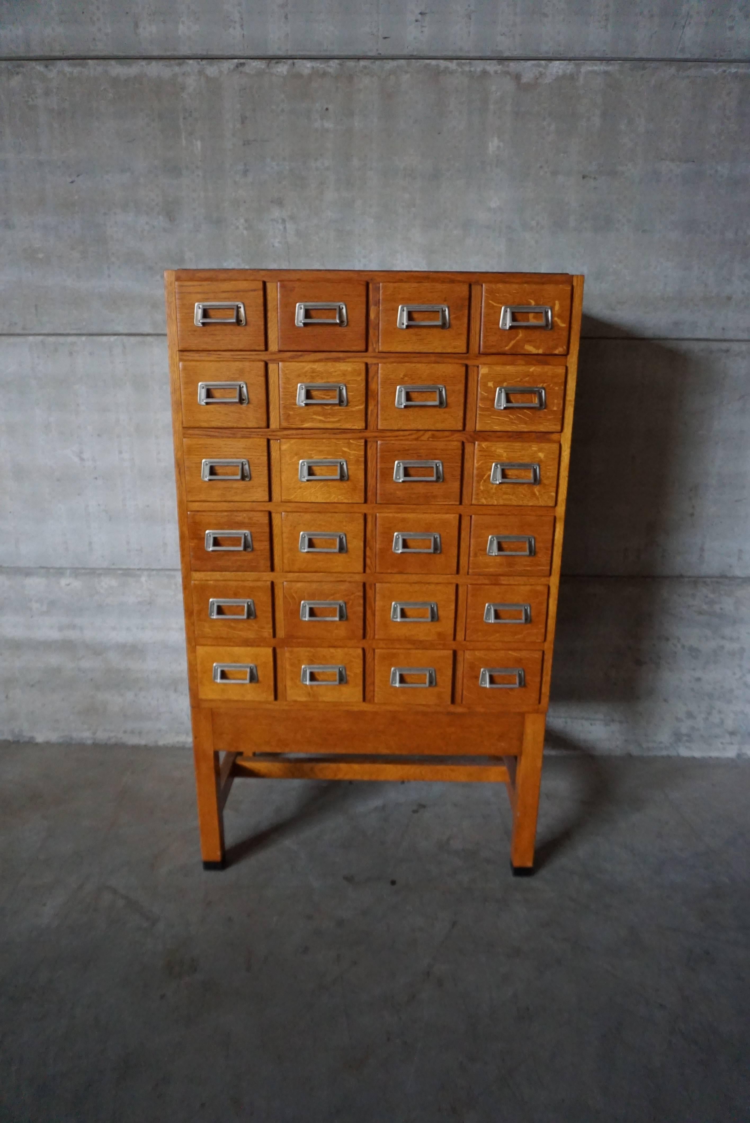 This Industrial wooden filing cabinet is made from oak and was designed and made in the 1950s. It is in a very good vintage condition with signs of use consistent with age.