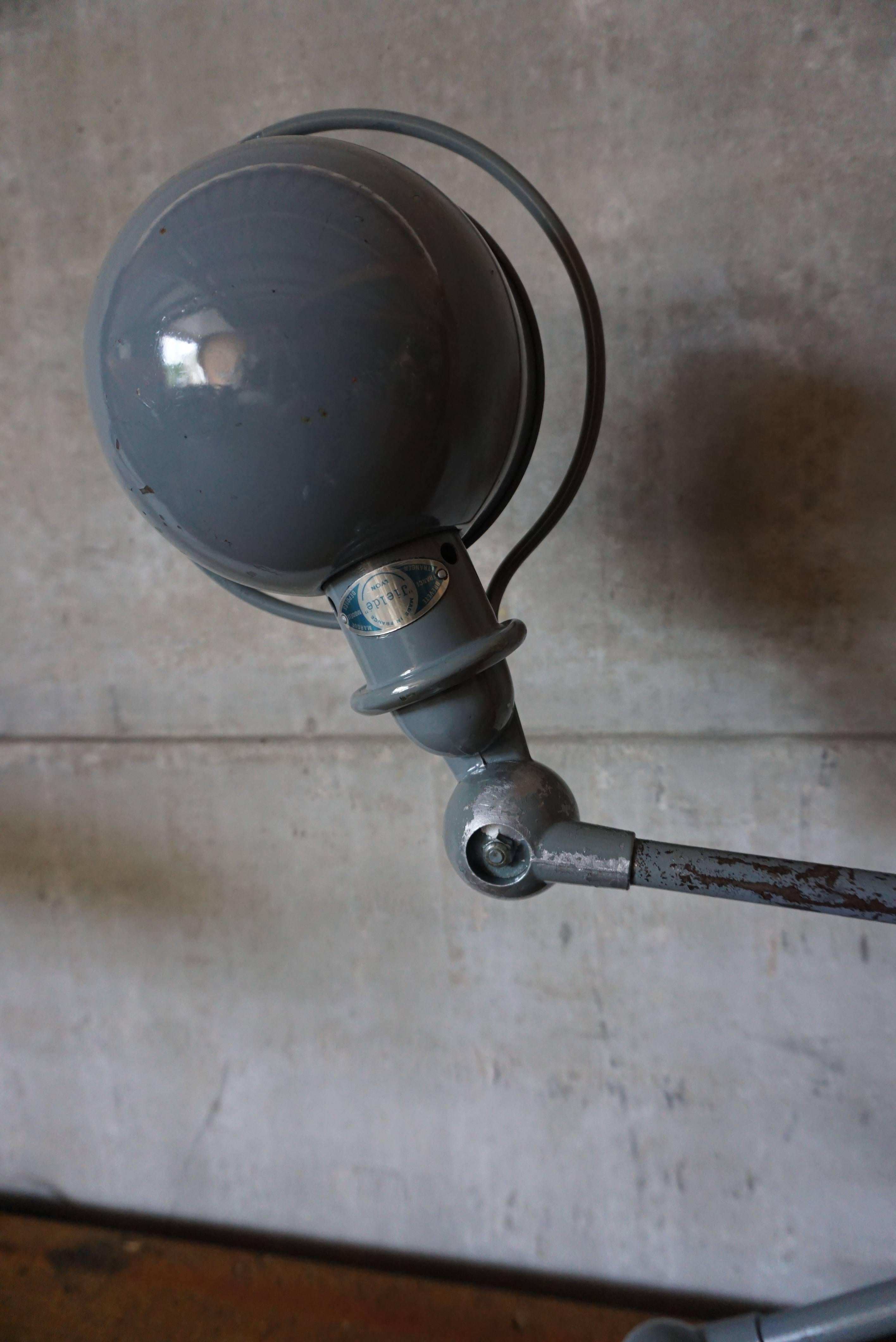 This two-armed Industrial lamp was manufactured by Jieldé in Lyon, France during the 1950s. The lamp is mounted on a clean brake disk. Each arm of the light measures 40cm. It has been fully restored, and is in a perfect vintage condition.