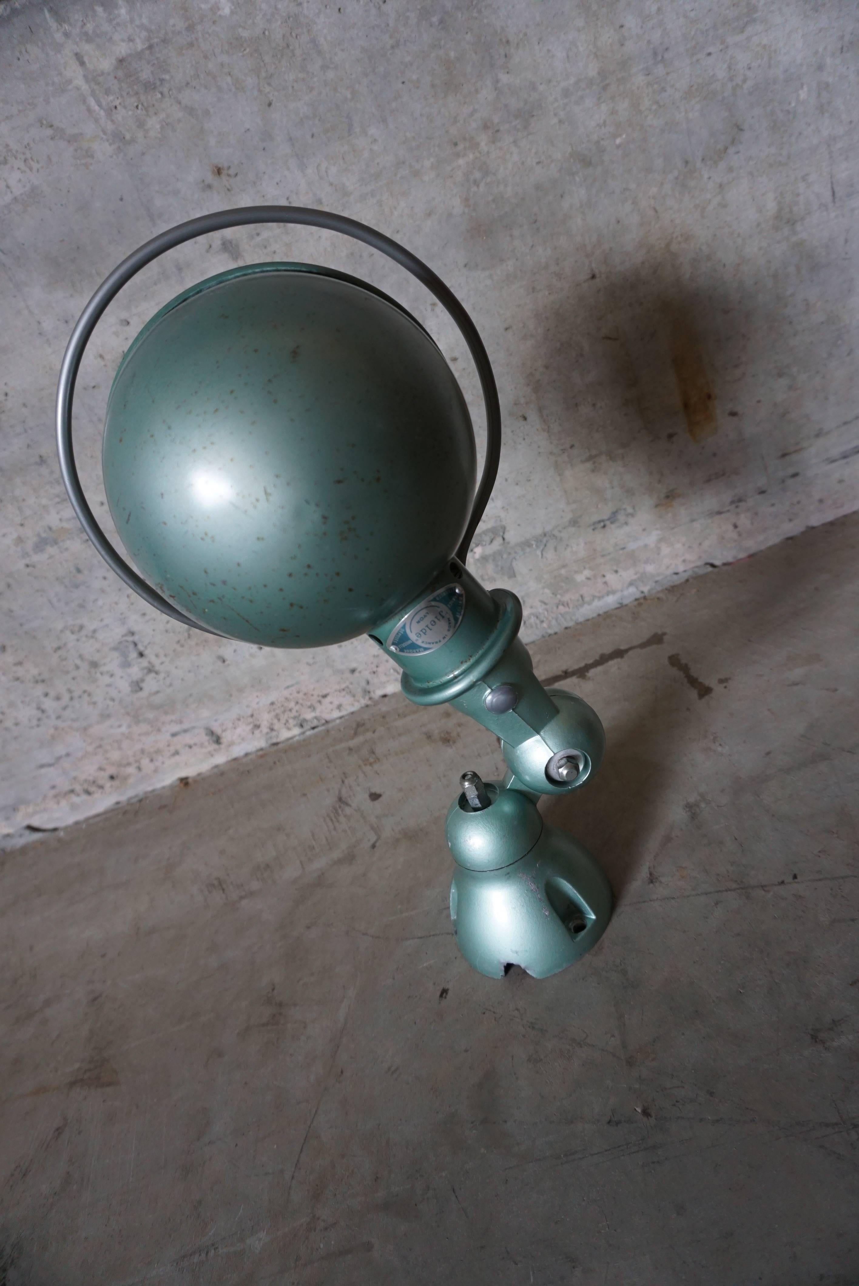 This wall lamp was designed by Jean-Louis Domecq, and in France by Jieldé during the 1950s. It is made from metal with a Vespa green finish. In very good vintage condition having been restored and rewired.