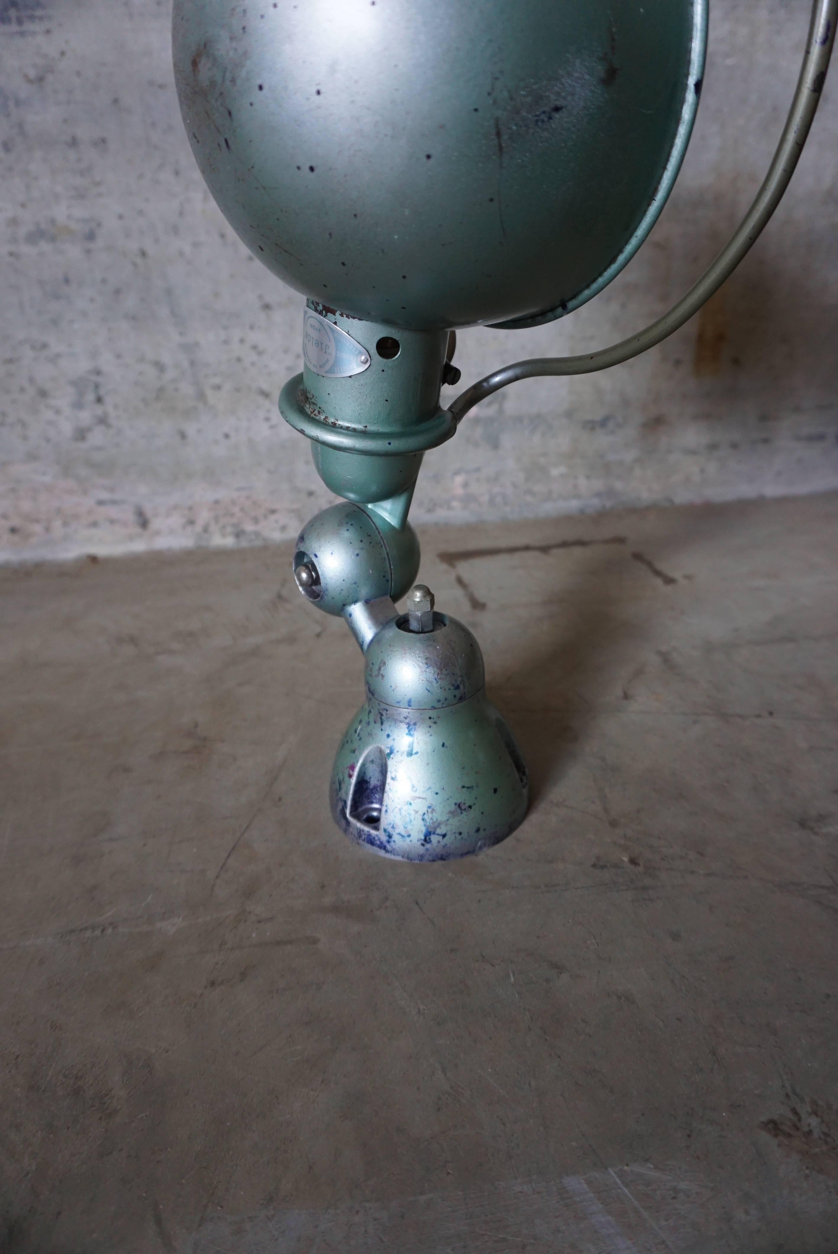 This wall lamp was designed by Jean-Louis Domecq, and in France by Jieldé during the 1950s. It is made from metal with a Vespa green finish. In very good vintage condition having been restored and rewired.
