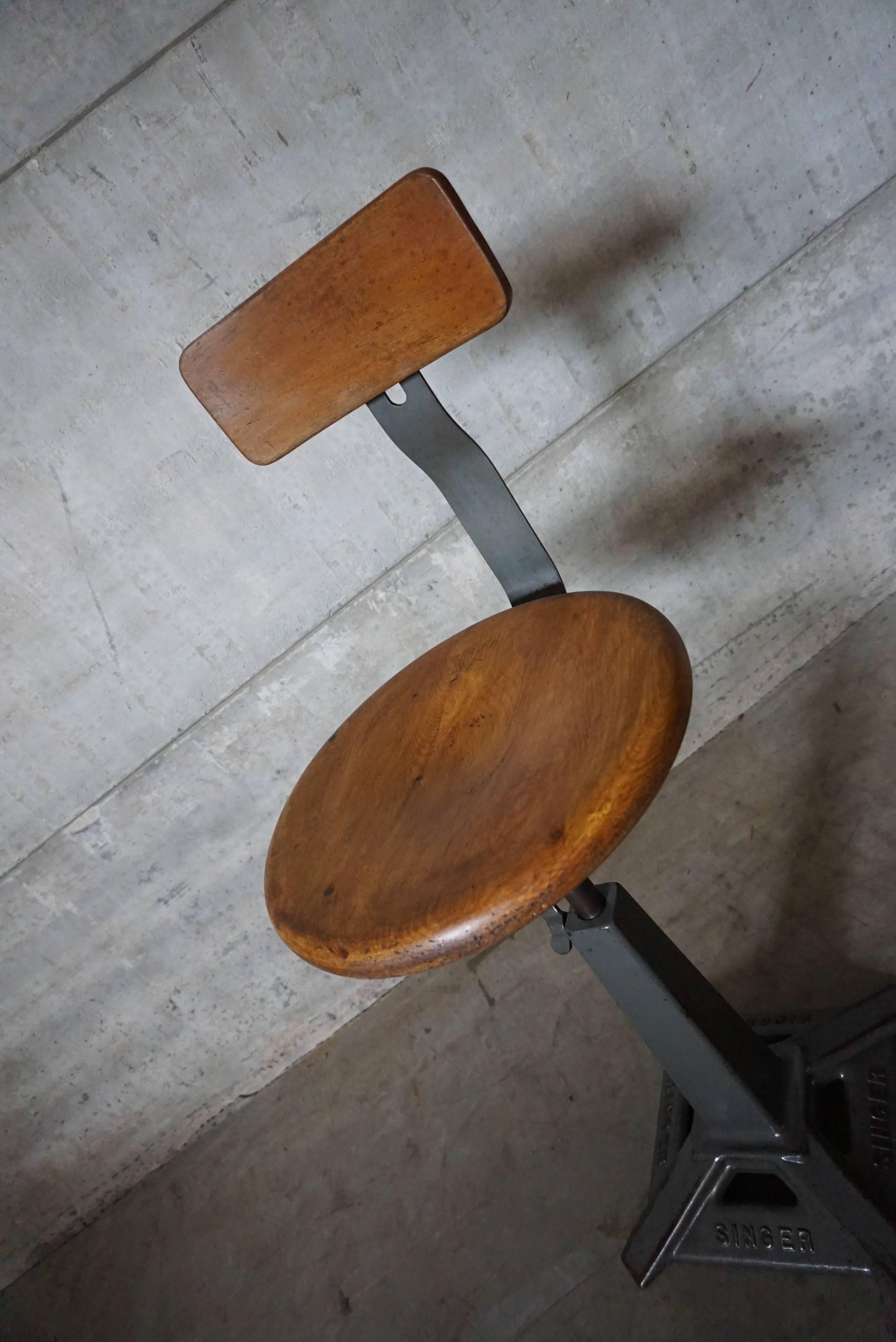 Singer machinist or work chairs. Branded cast iron base with factory painted finish, steam bent ply seat and back rest. Manufactured by “simanco” the Singer manufacturing company, England, 1930s.
