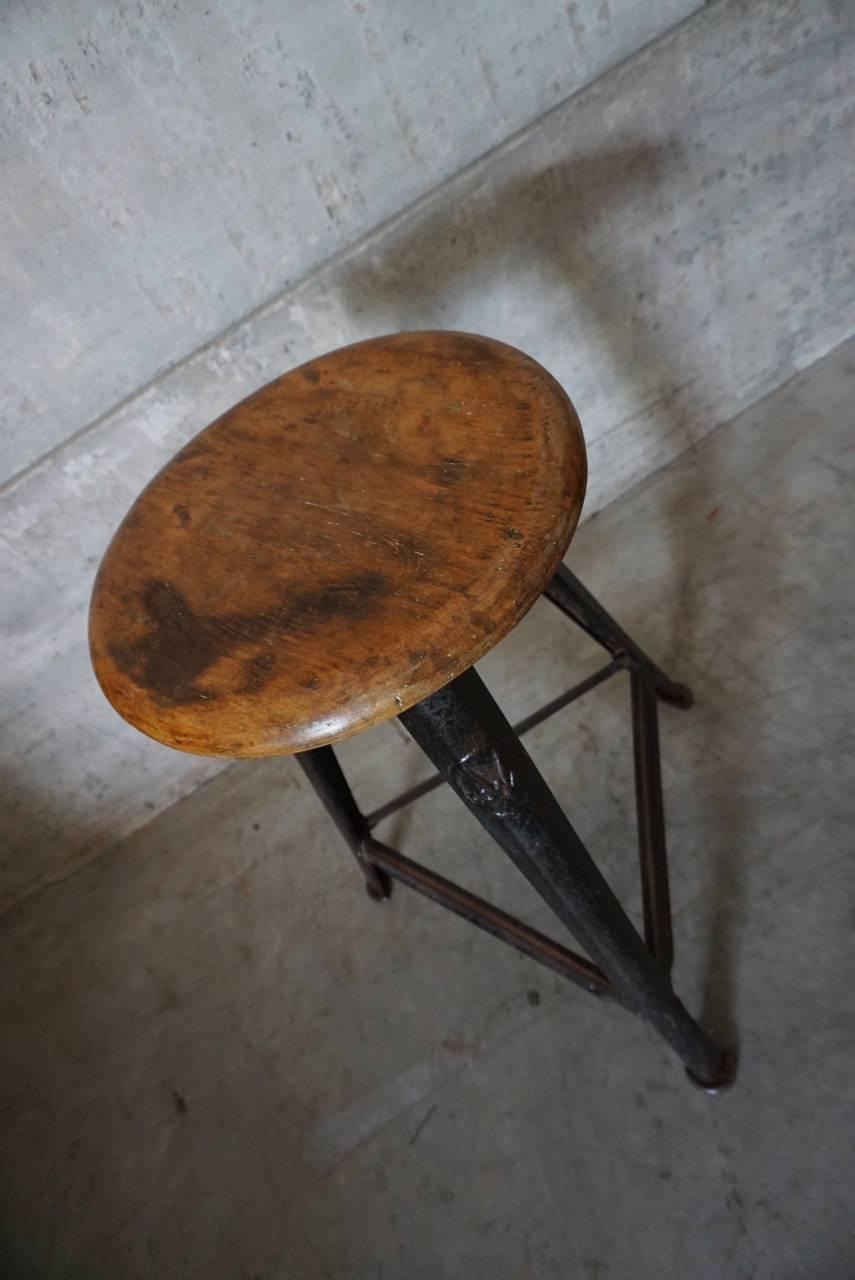 This vintage stool was manufactured by Rowac in Germany, during the 1930s. The frame is made from metal while the seat is made from wood.