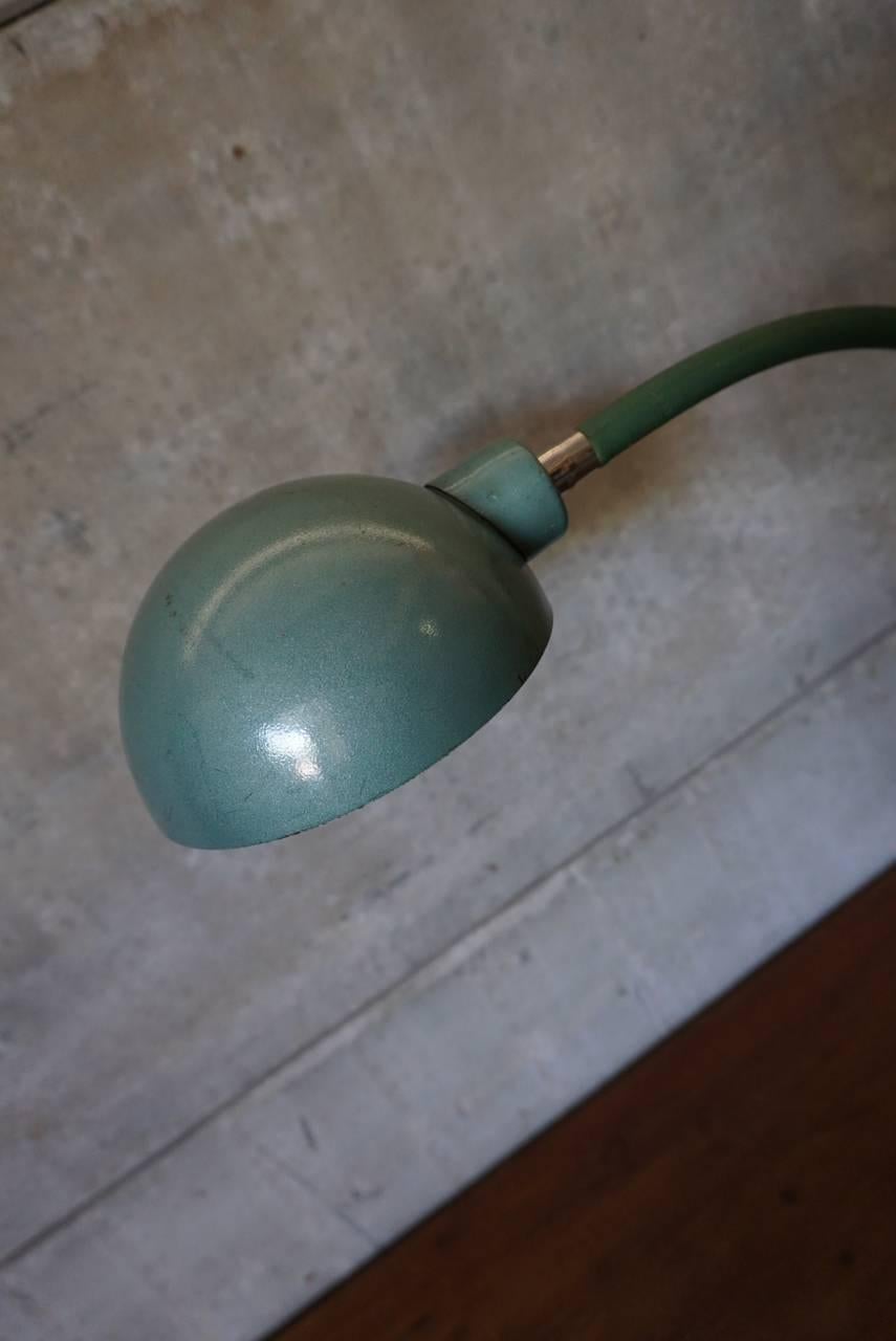 This Industrial lamp was manufactured by Lampe Adher, France during the 1950s. The lamp is mounted on a clean brake disk. It features a flexible arm and lampshade. The lamp has been fully restored and is in a good vintage condition.