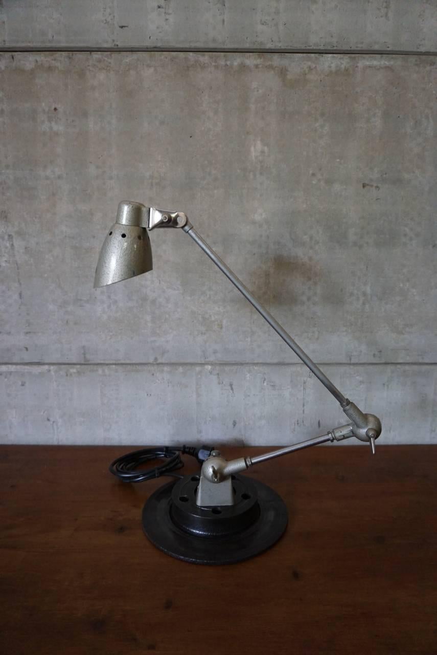 This Industrial desk lamp was manufactured by the company Pfaff in the 1950s.
