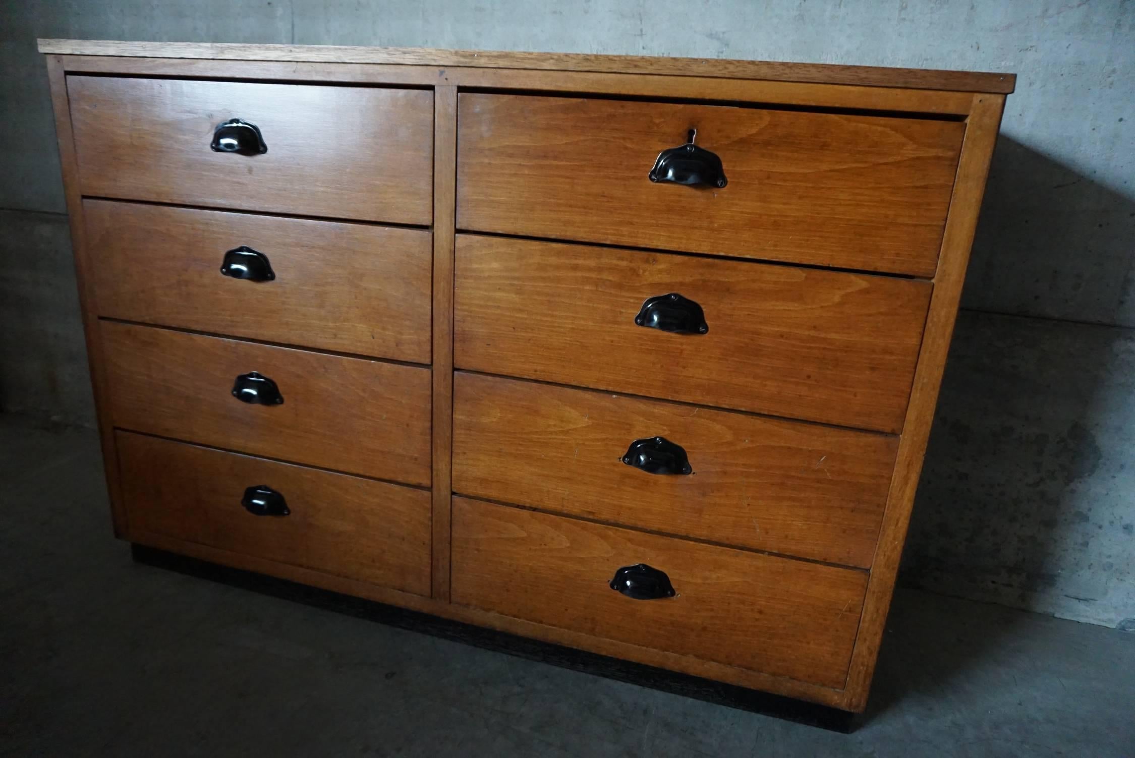 This apothecary bank of drawers was designed and made around the 1950s. The piece is made from oak fronts with cup handles.