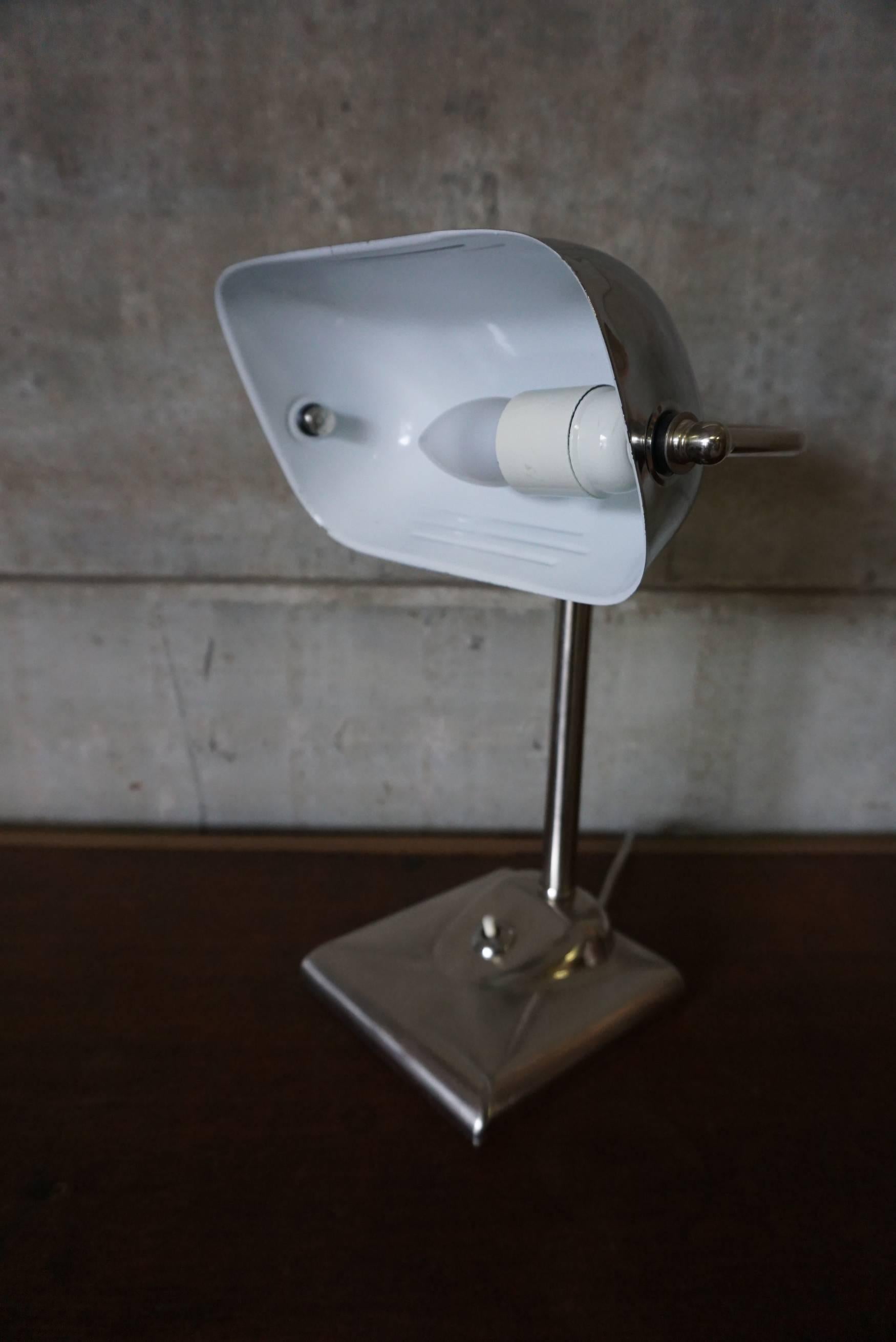 This table lamp was designed around the 1930s and produced in Germany. The base and shade are made of chrome-plated metal. The light is in good condition with only minor signs of wear and it is equipped with a E27 sockets and rewired.