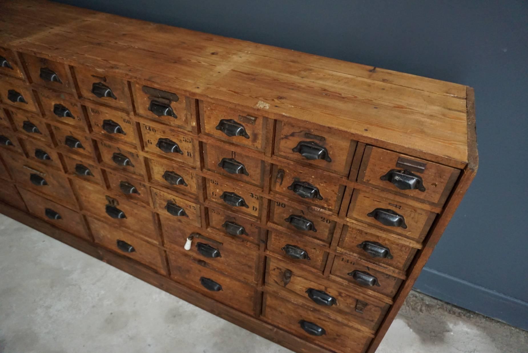 This apothecary bank of drawers was designed and made circa 1920s-1930s in France. The piece is made from oak with metal handles. It was used in a hardware store.