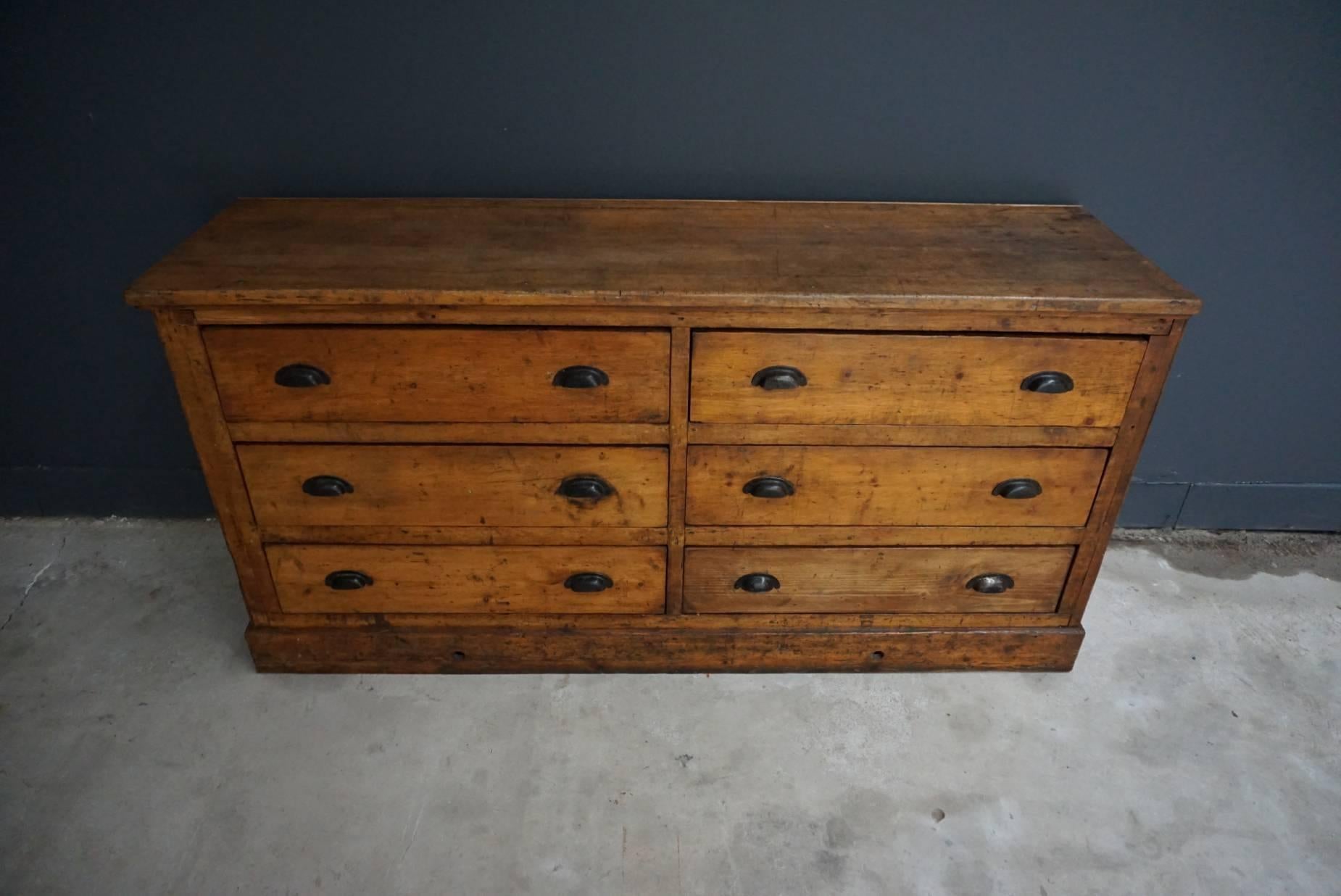 This apothecary bank of drawers was designed and made circa 1930s in France. The piece is made from pine and beechwood with metal handles. It was used in a factory for chalks. We have a matching cabinet in another listing.