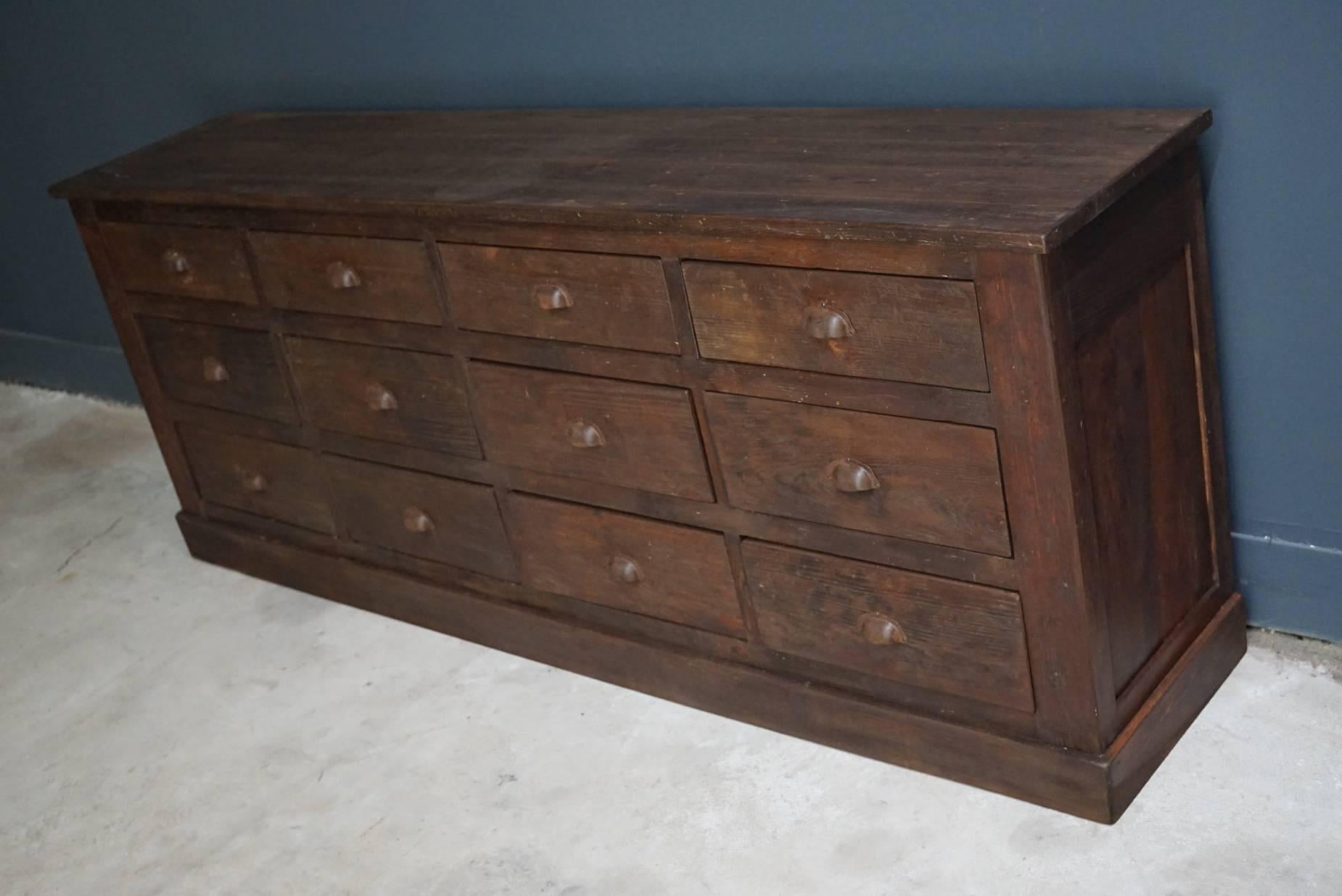 This apothecary bank of drawers was designed and made circa 1950s in France. The piece is made from pine and features drawers with cup handles.