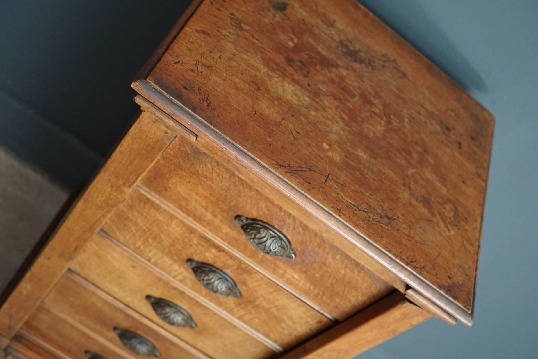 This apothecary bank of drawers was designed and made circa 1920s in France. The piece is made from beechwood and features drawers with cast iron cup handles.