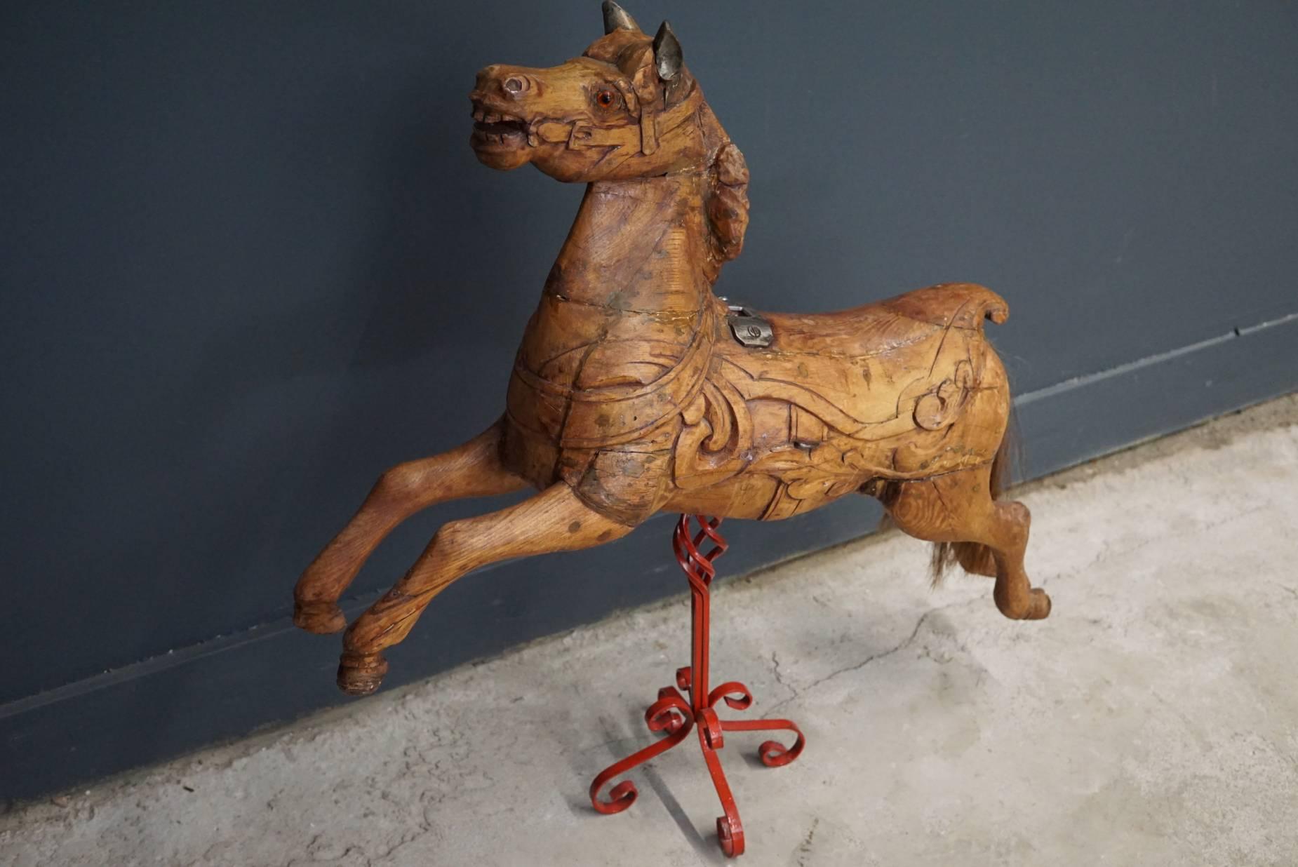 This carved carousel horse was made in England, circa 1890 by the famous carver Anderson. It is in a good condition and mounted on a metal stand.