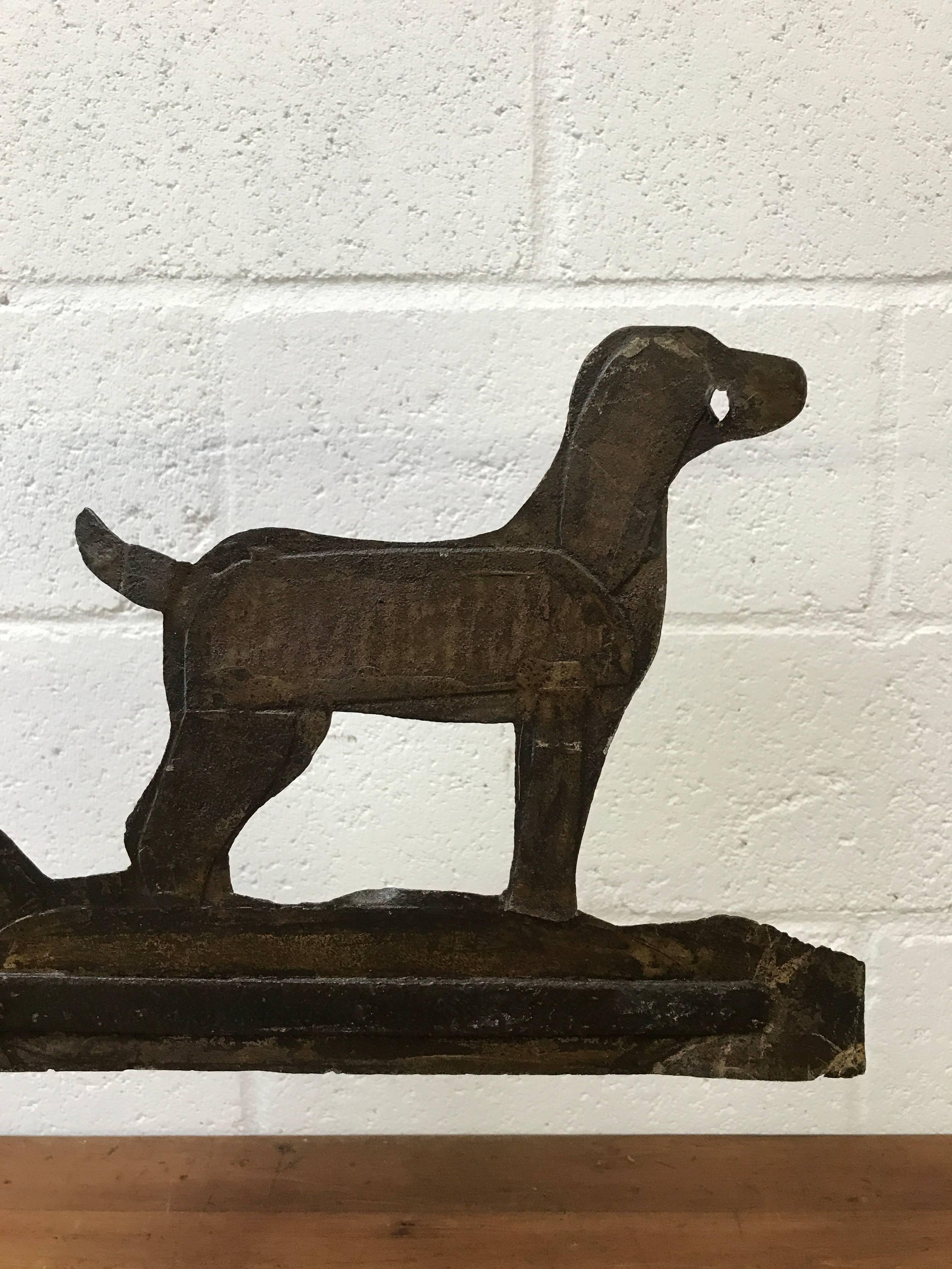 An antique French Weathervane man and his dog hunting. Primitive in construction and a great subject. Made from sheet zinc with traces of old paint.
