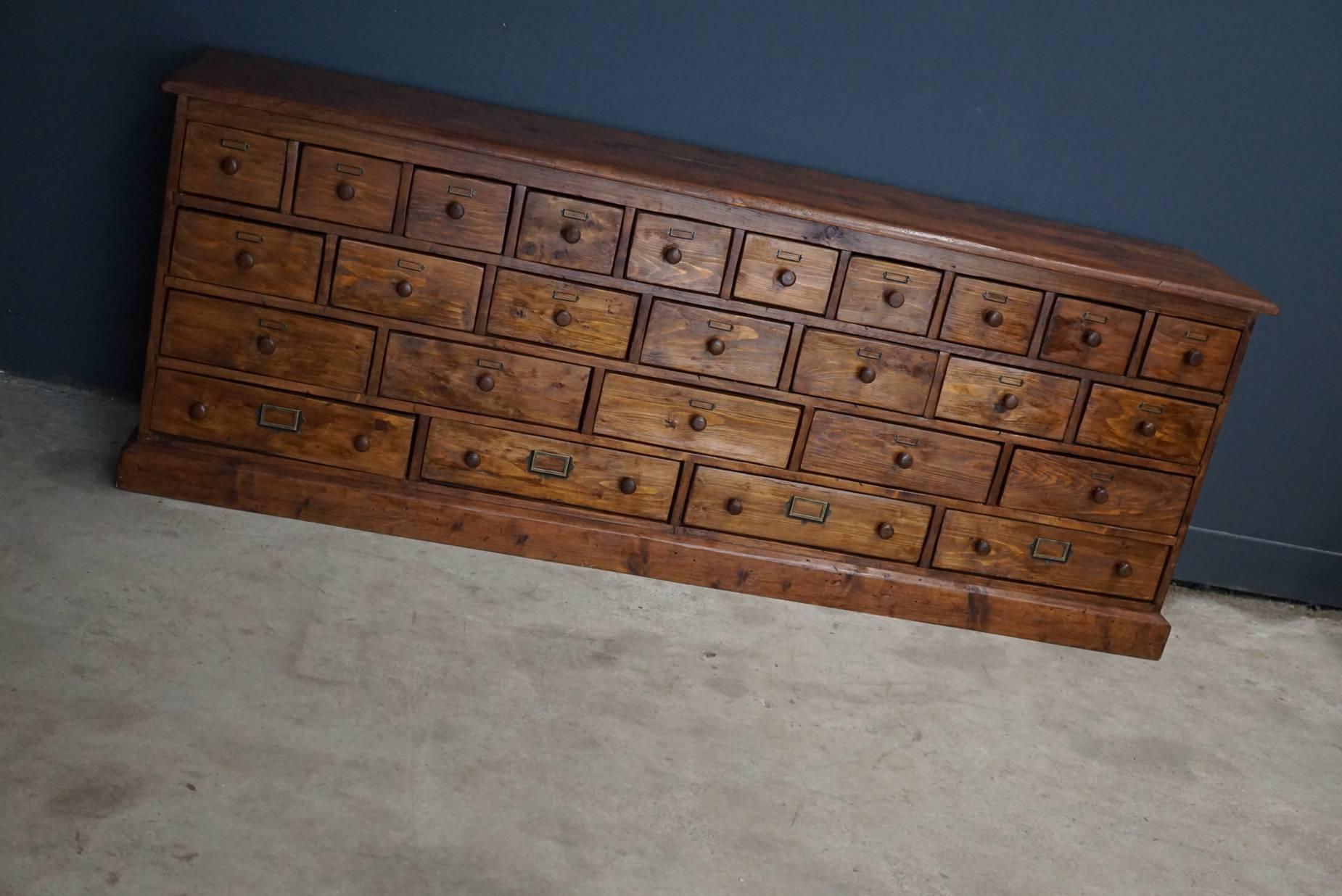 This apothecary cabinet of drawers was designed, circa 1900s in Germany. The piece is made from pine and is in a good vintage condition.