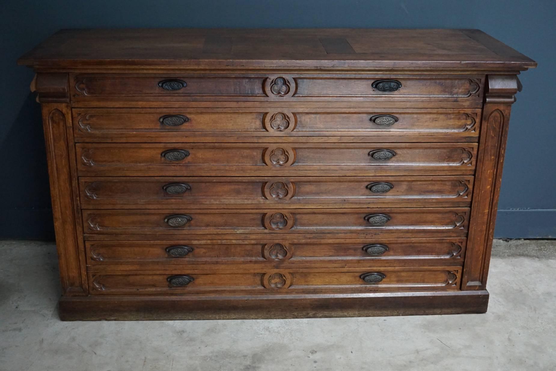 This bank of drawers was designed and made in the late 19th century in France to be used in a church. The piece is made from oak with cast iron hardware.