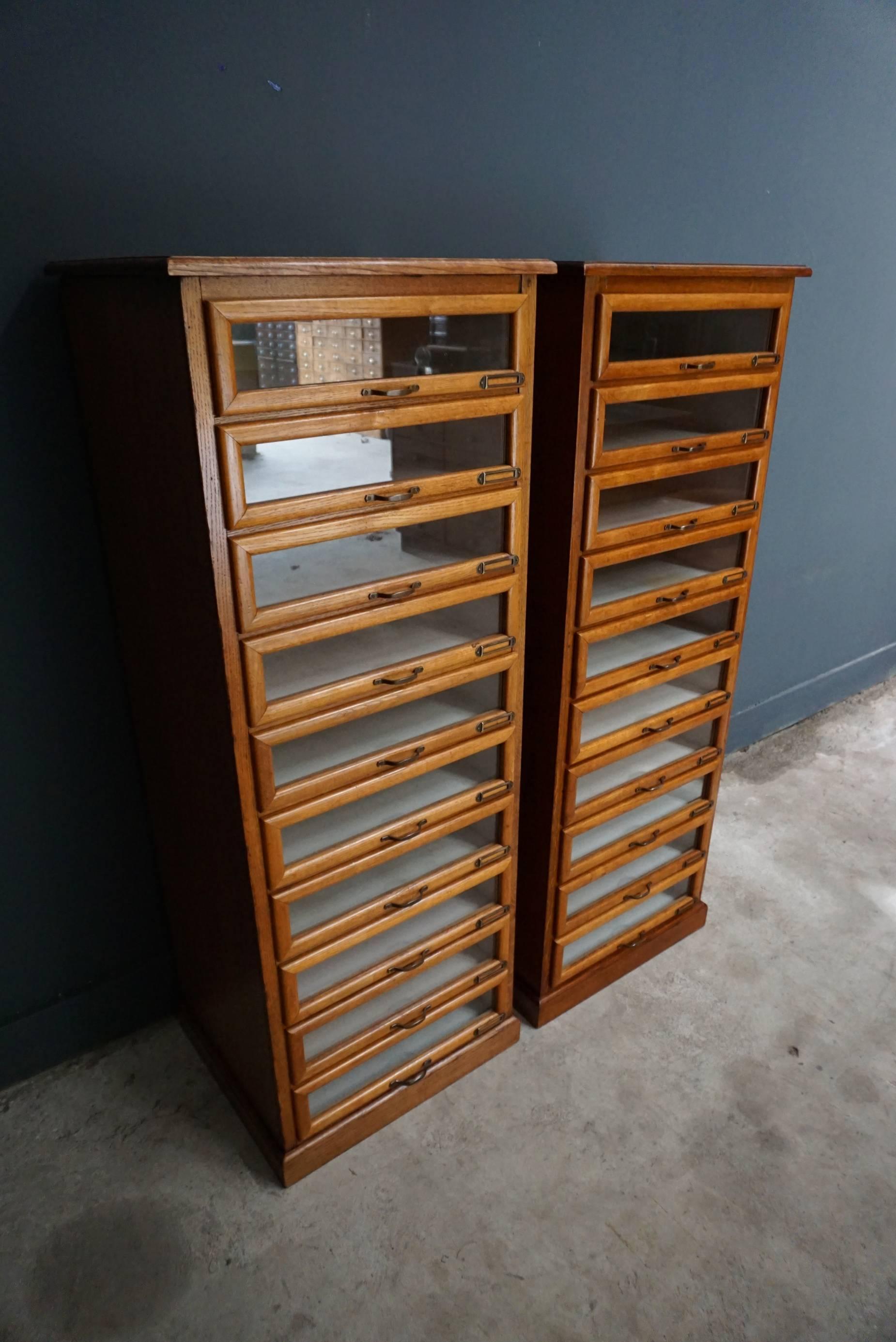 This vintage haberdashery shop cabinet originates from the United Kingdom. It is made from oak and features 10 drawers. It is restored and the drawers open and shut smoothly. The inside of the drawers measure 42.2 x 45 x 11 cm