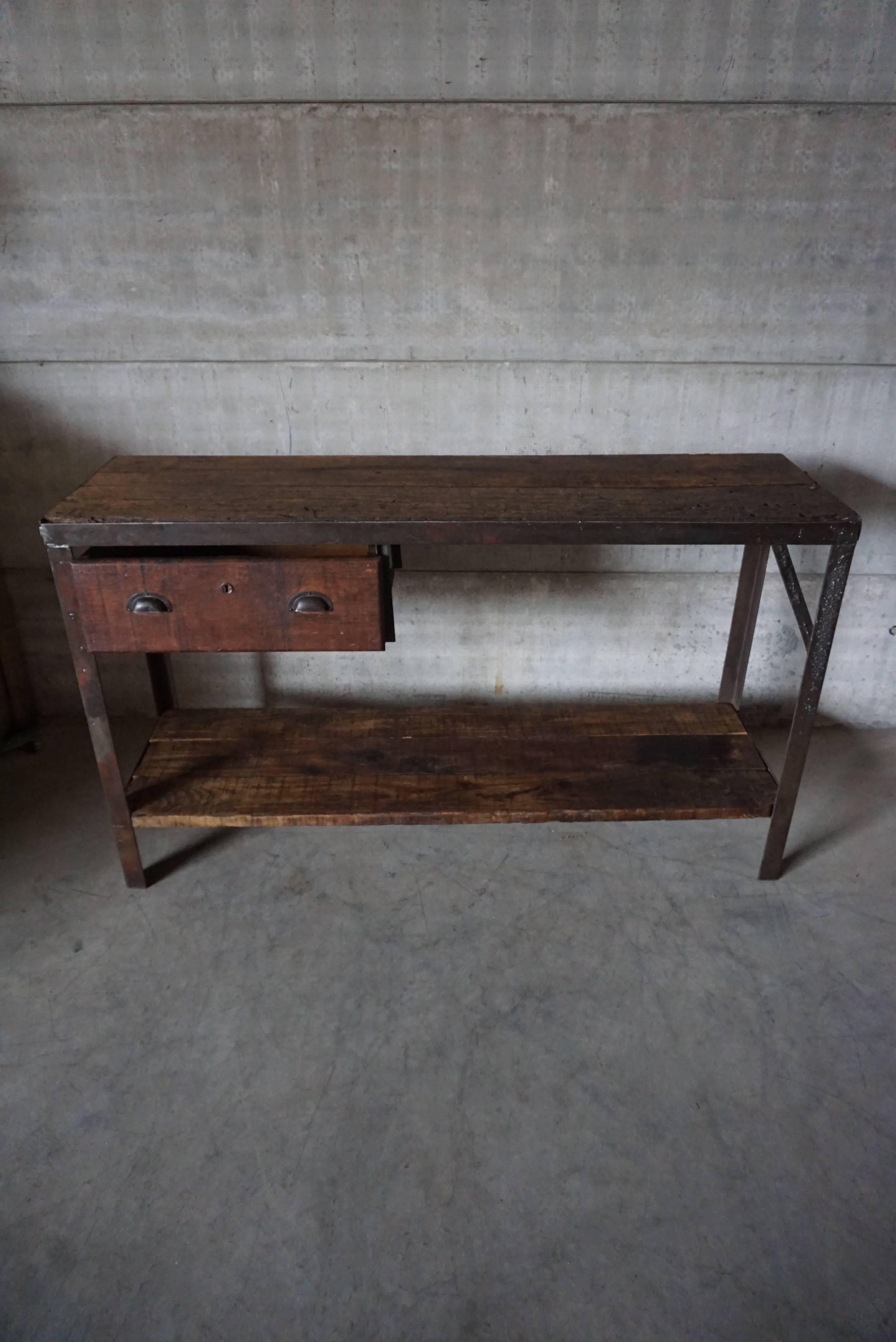 Nice old handmade workbench with industrial looks. Great as a side table, industrial desk, or for shop interiors. The top and bottom are made from old patinated Oak.