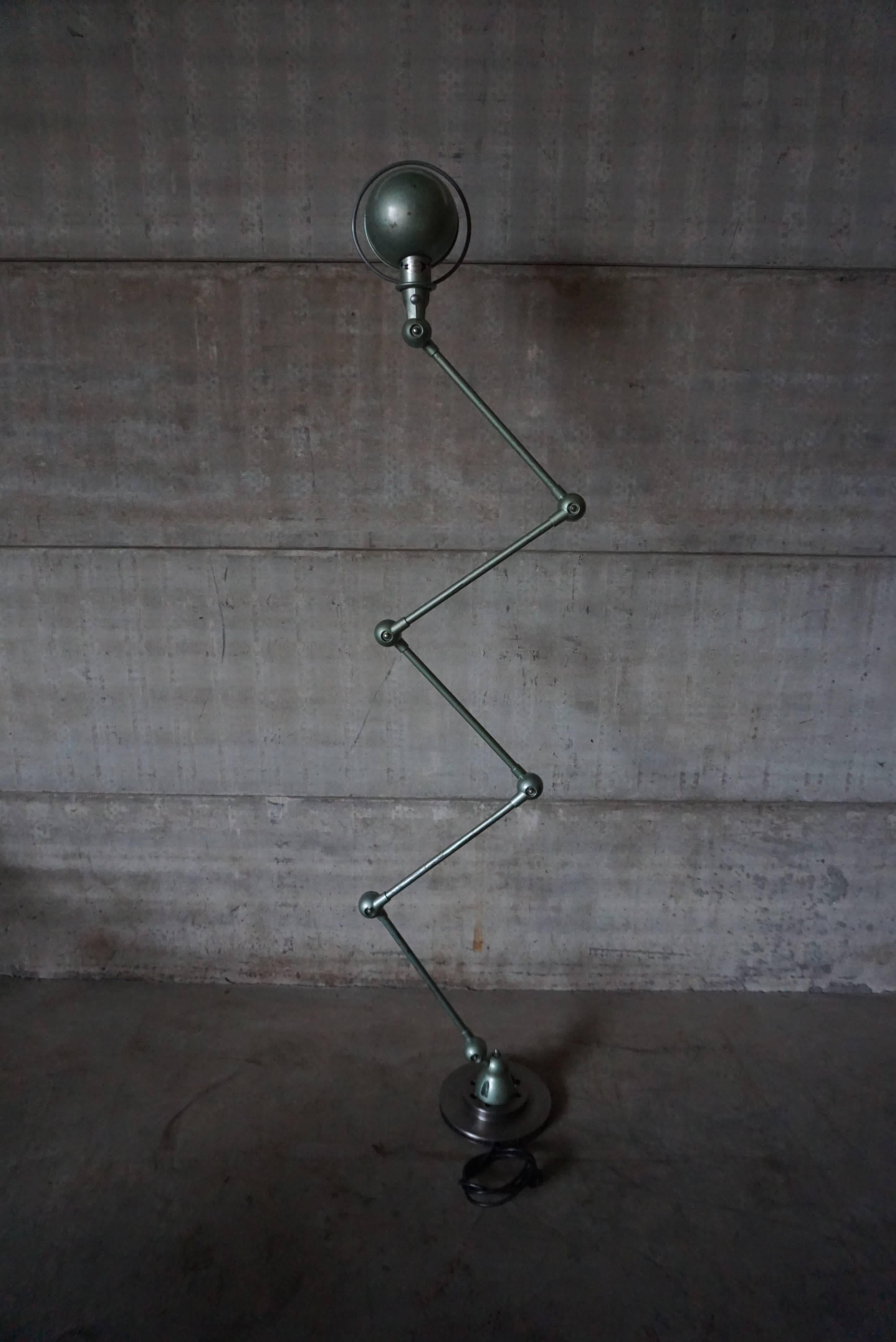 This five-armed industrial lamp was manufactured by Jieldé in Lyon, France during the 1950s. The lamp is mounted on a clean brake disk. Each arm of the light measures 40cm. It has been fully restored, and is in a perfect vintage condition. 