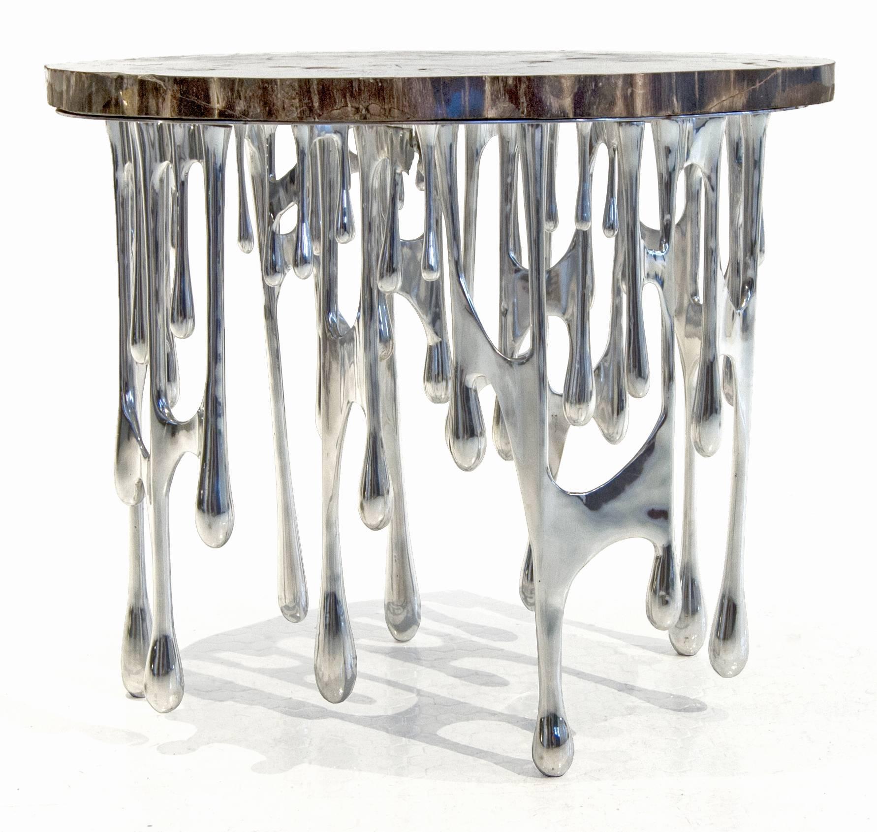 This stunning piece is one of a series of 20. Each top slab is unique and each design has its subtle differences. The dripping table could be used as a iconic end table or an art piece on its own.